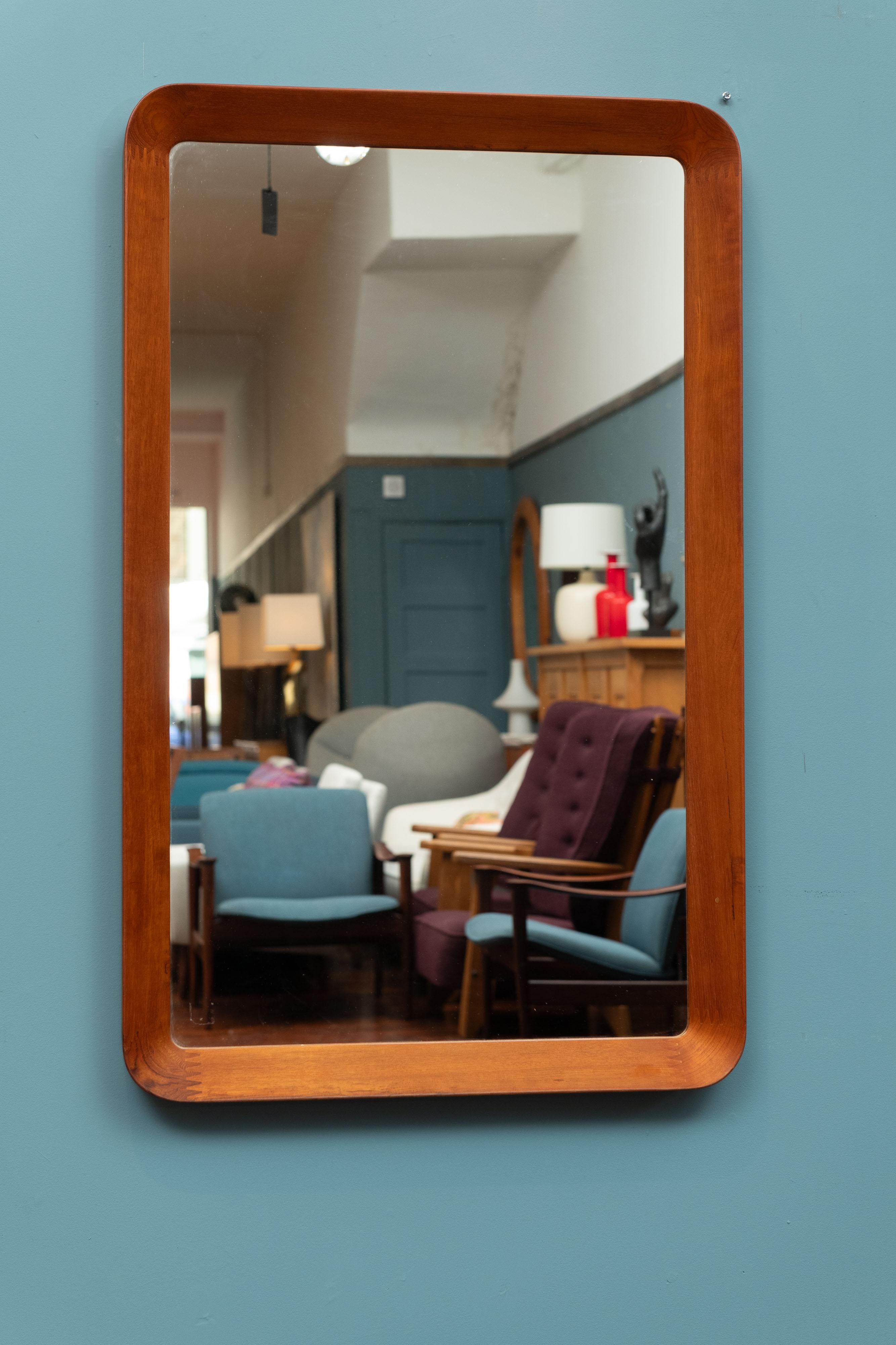 Pedersen & Hansen rare larger size teak wall mirror, Denmark. Impressive sculpted frame with finger joints at the corners and an inverted teak frame. Made with high quality materials and cabinetry techniques, labeled.