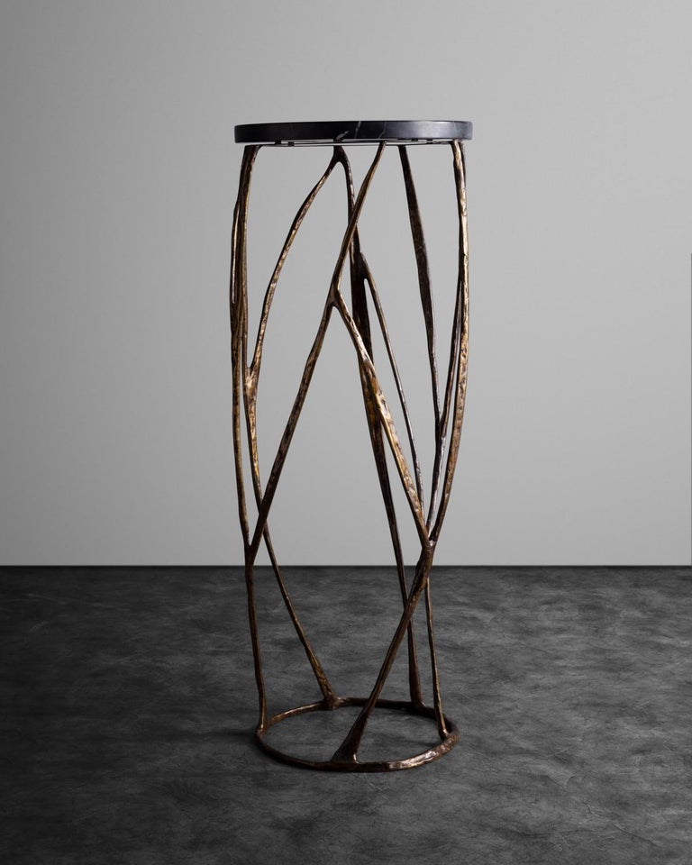 Patinated bronze base in the shape of organic strands, supporting a circular black marble top. Limited edition of 8. 
Custom sizes and finishes available.