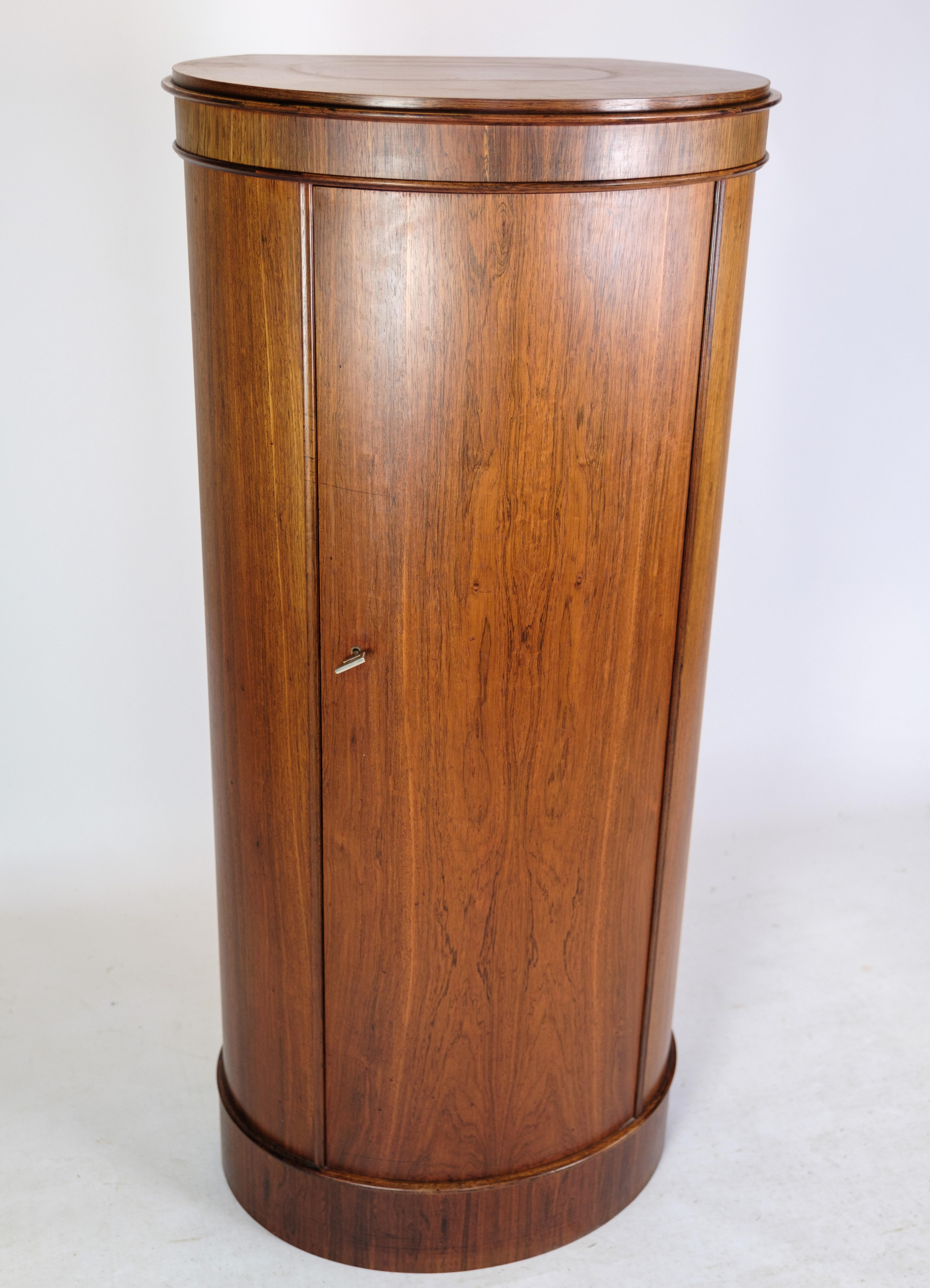 Oval rosewood Pedestal cabinet made of rosewood and designed by Johannes Sorth for Bornholms Møbelfabrik around the 1960s. Incredibly nice condition.
Dimensions in cm: H:130 W:60 D:42