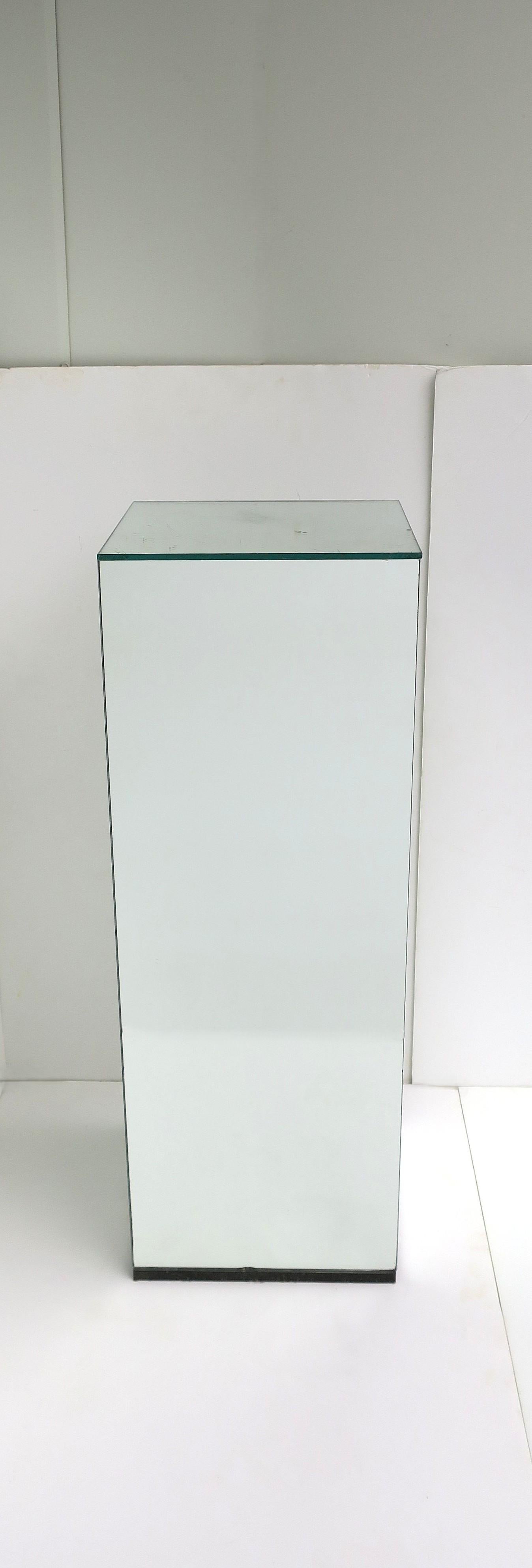 A mirrored pedestal column stand, in the Modern style, circa late-20th century, 1970s. Display sculpture, a plant, books, a light/lamp, urn, etc. 