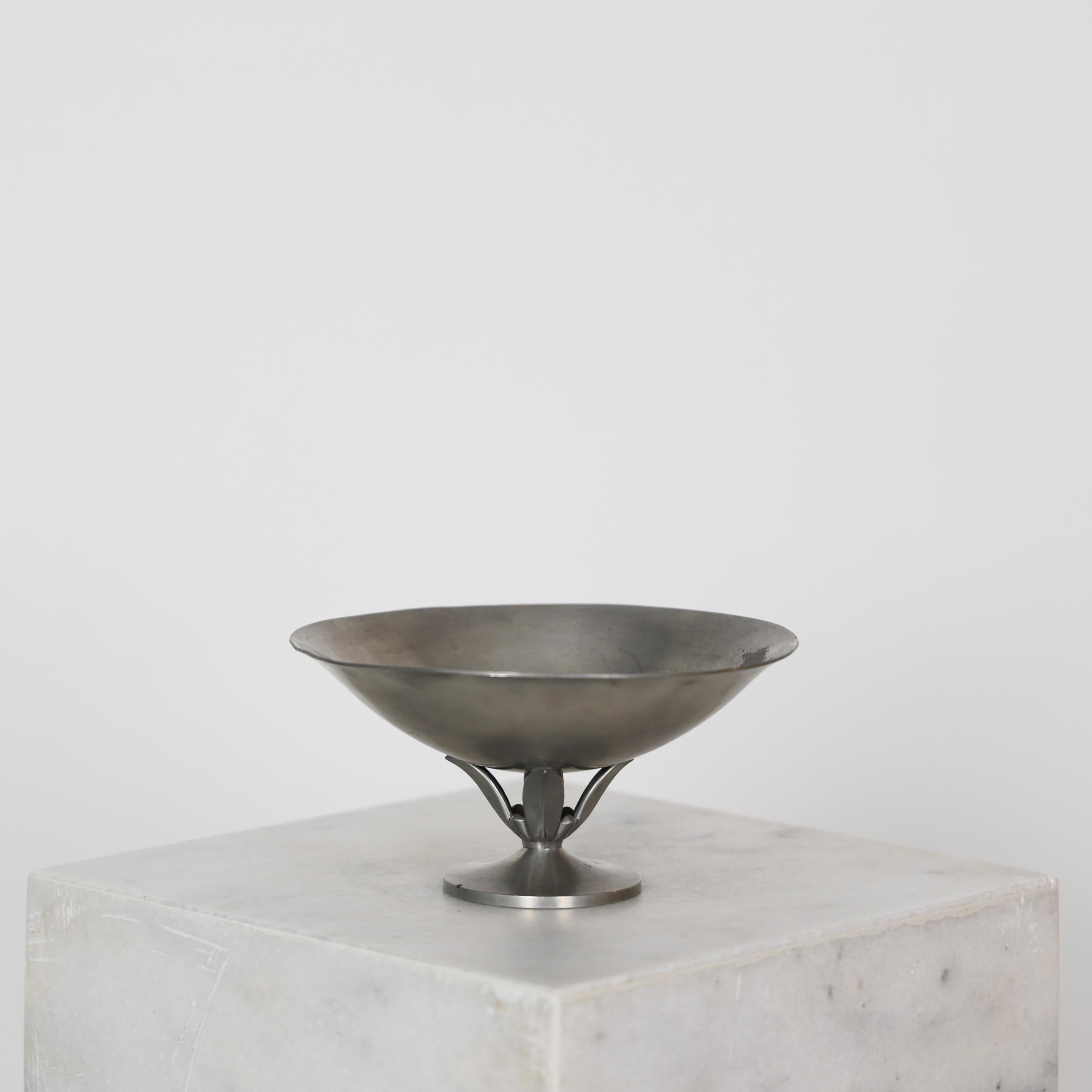 Elegant Pedestal Pewter Bowl designed by Just Andersen in the 1920s. 

* Pedestal pewter bowl
* Designer: Just Andersen
* Style: 1101
* Year: 1918-1929
* Condition: Fair vintage condition. Makers engravings intact. Slight out of shape with dents and