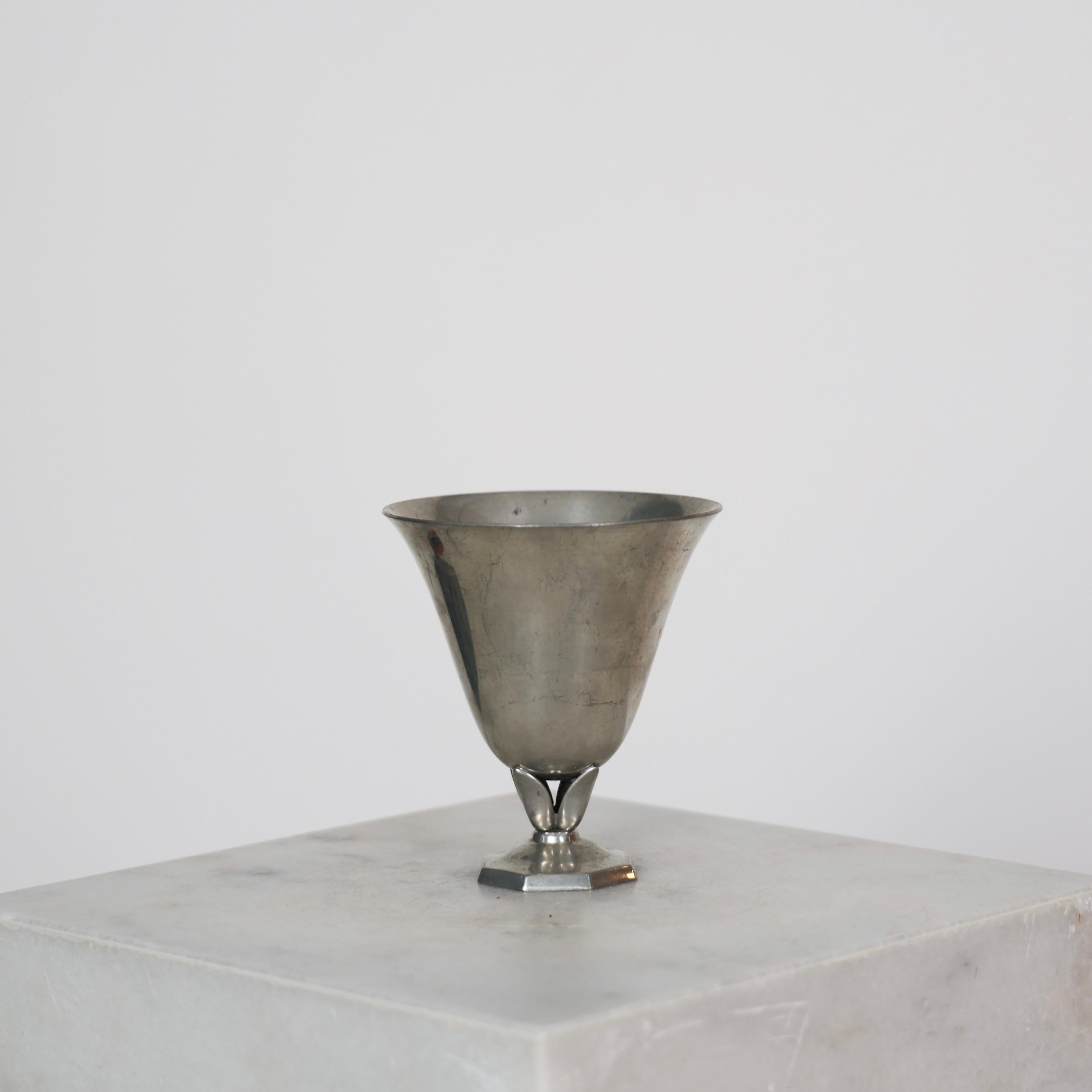 Elegant Pedestal Pewter Vase designed by Just Andersen in the 1920s.

* Cone-shaped pewter vase on foot
* Designer: Just Andersen
* Manufacturer: Just Andersen
* Style: 1213
* Year: 1926-1929
* Condition: Good vintage condition. Makers engraving