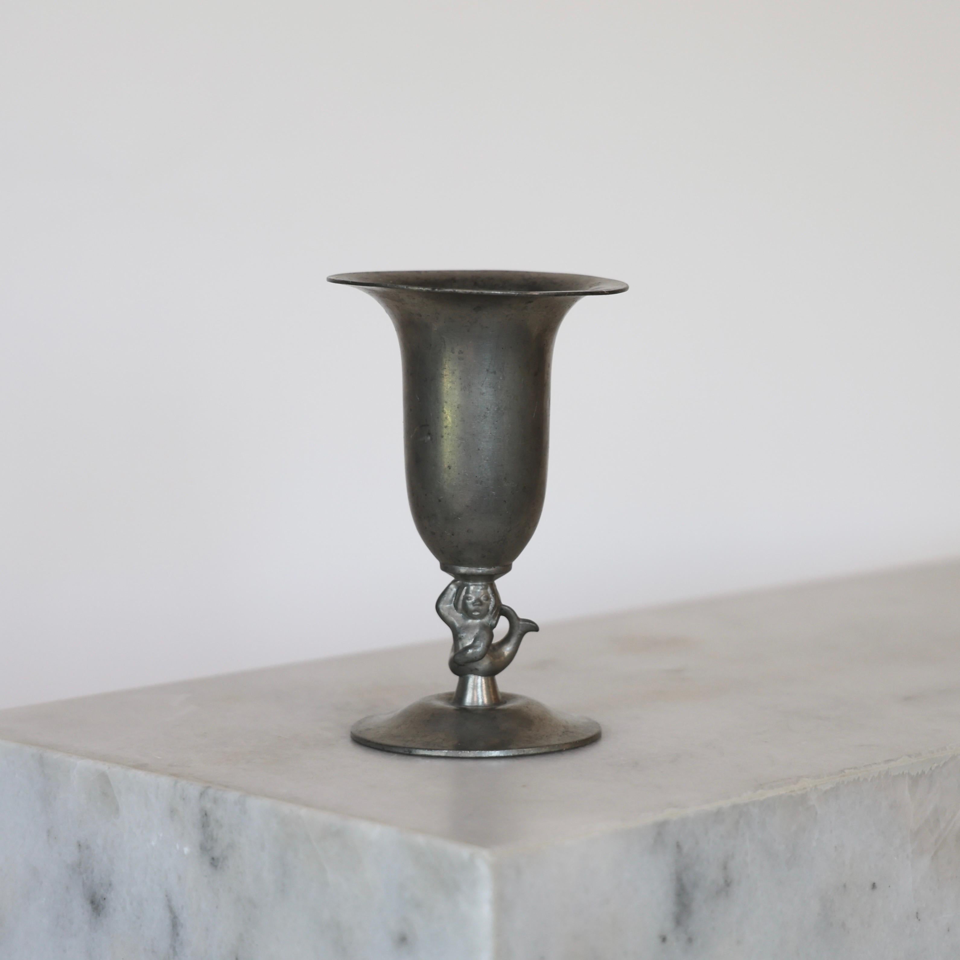 Exquisite Pedestal Pewter Vase designed by Just Andersen in 1930. 

* Pedestal pewter vase with a mermaid 
* Designer: Just Andersen
* Manufacture: GAB Sweden
* Style: 1132
* Year: 1930
* Condition: Fair vintage condition. Makers engraving intact.