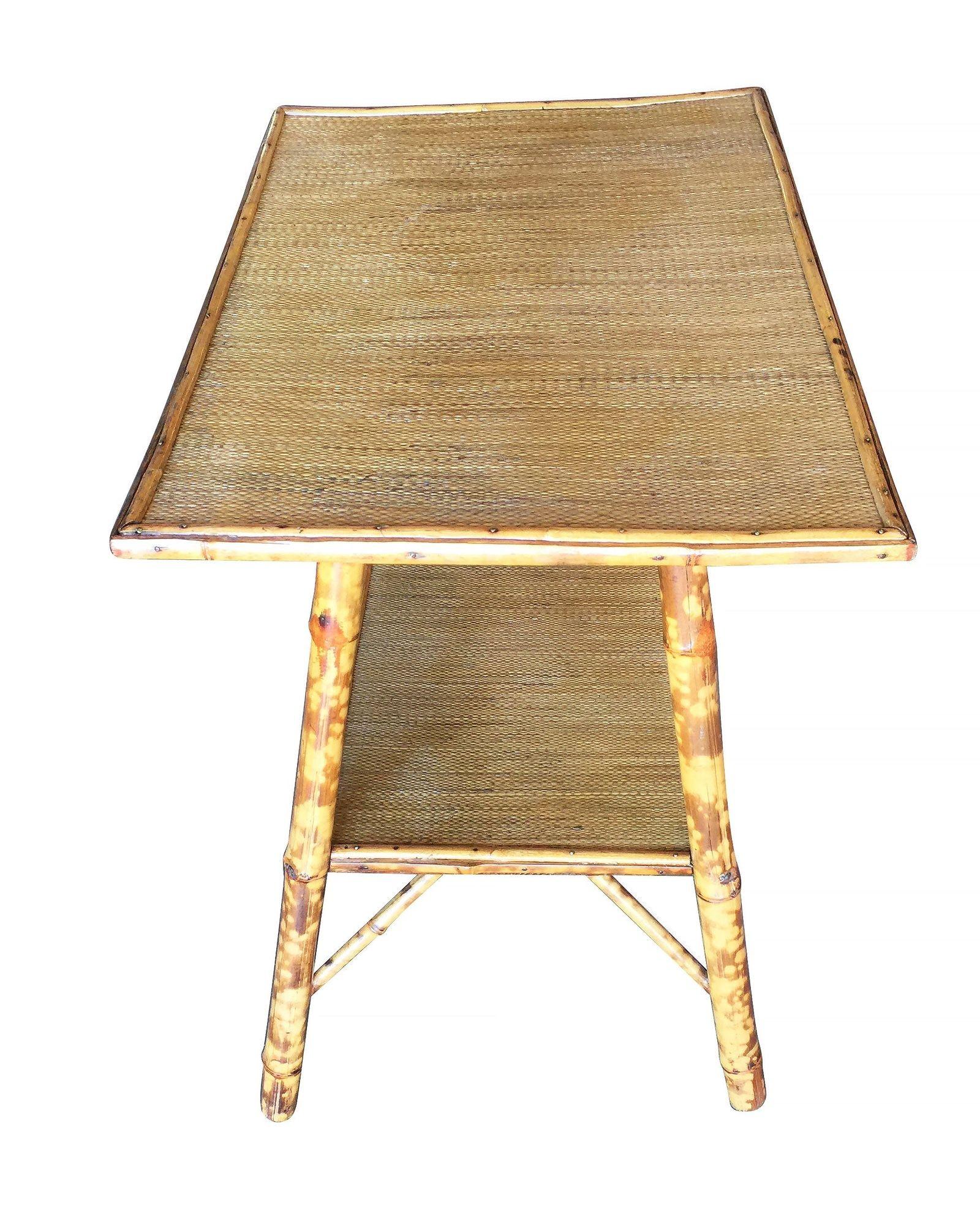 Antique Ascetically Movement tiger bamboo pedestal side table with rice mat top and secondary bottom shelf.

Restored to new for you.

All rattan, bamboo and wicker furniture has been painstakingly refurbished to the highest standards with the best