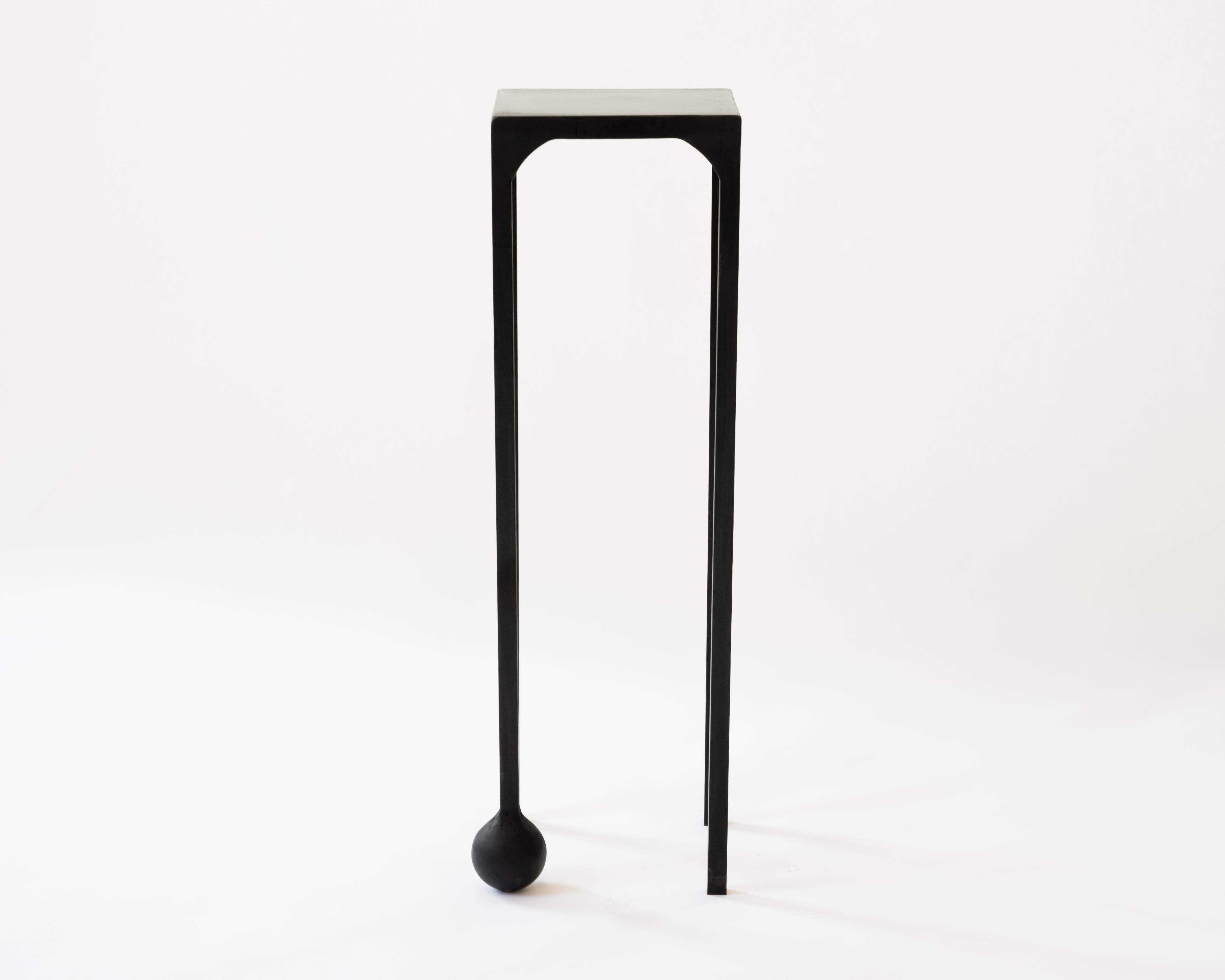 TABLE NO. 2 - Pedestal 
J.M. Szymanski
d. 2019

This geometric, solid, steel structure is supported by a cast-sphere base. The refined simplicity of this design speaks volumes, and adds depth and intrigue to any space. 

Custom sizes available. Made