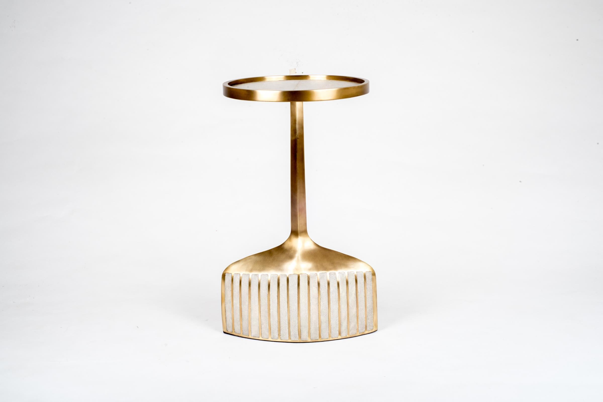 The pedestal side table in small is the perfect accent piece due to its sleek and light aesthetic. The small size is inlaid in cream shagreen and bronze patina brass. The large size is also available that is inlaid on the top surface with black