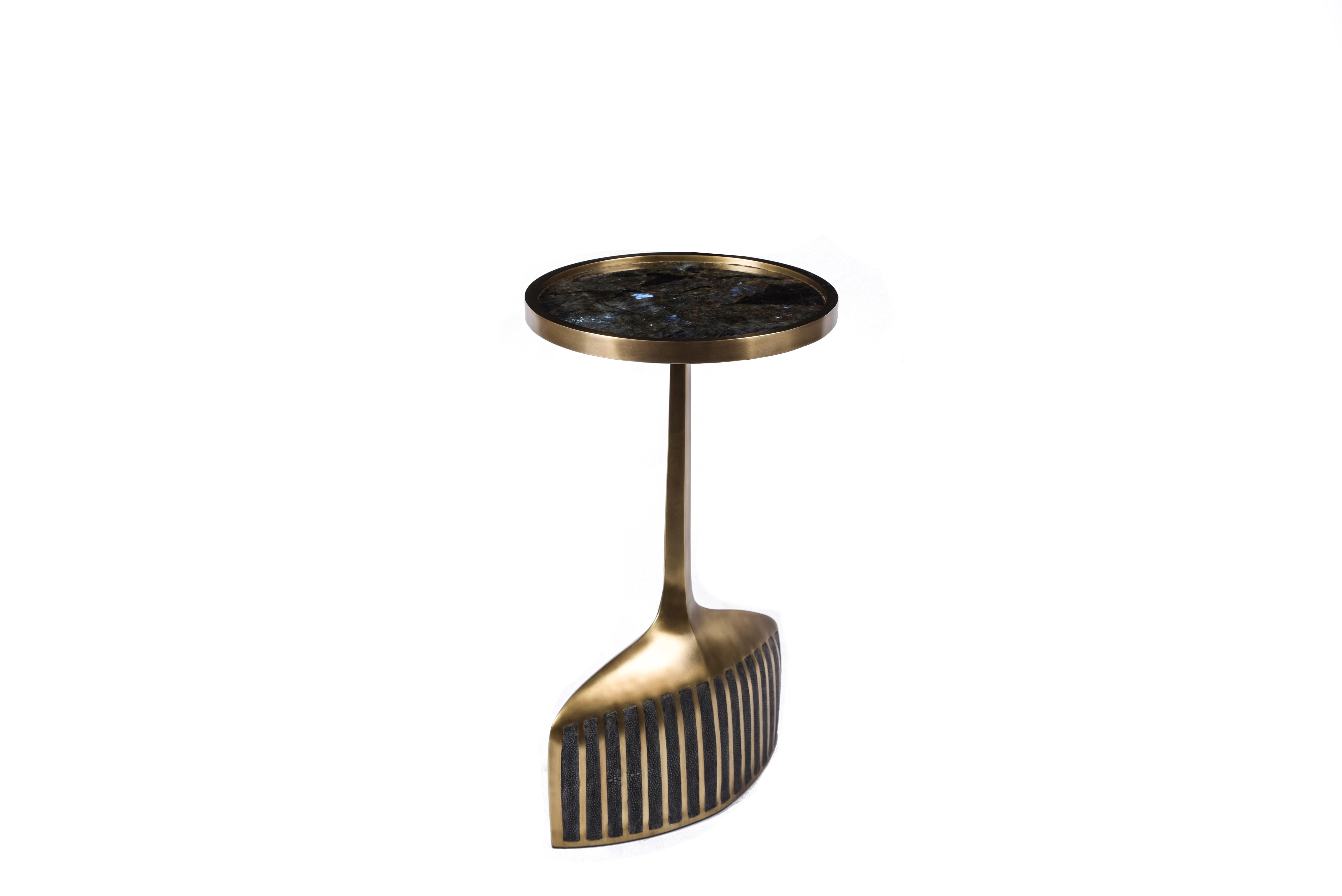 The pedestal side table small is the perfect accent pieces due to its sleek and lightweight aesthetic. The small size is inlaid on the top surface with Lemurian Quartz and the bottom part a mixture of coal black shagreen and bronze patina brass.