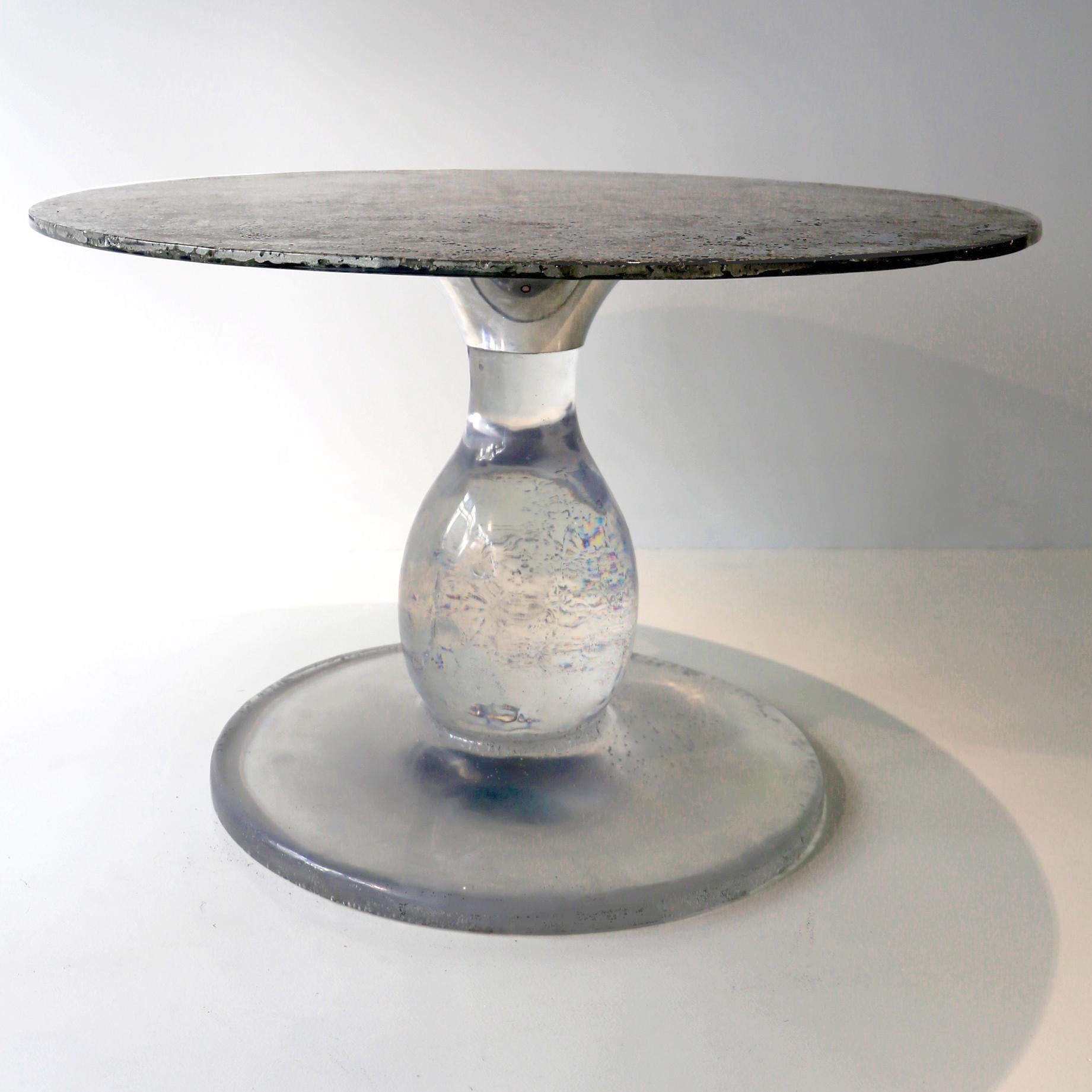 In stock, made in France: On a galactic crystal pedestal, made of the clearest resine, this contemporary pedestal table is a unique piece, created by Xavier Lavergne and sold with its authenticity certificate. The top is made of melted pewter with