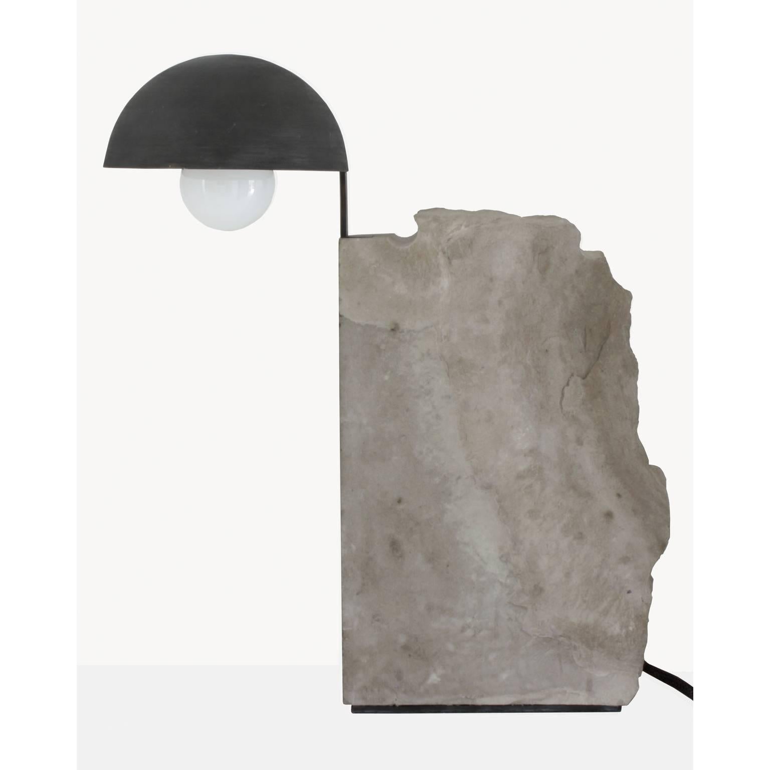 Brazilian contemporary table lamp by designer Gustavo Neves
Aeon collection
The Pedra table lamp
Materials: stone (limestone), metal (brass) darkened with manual treatment.
Brazil
2017
For this project, Gustavo Neves designed the collection Æon