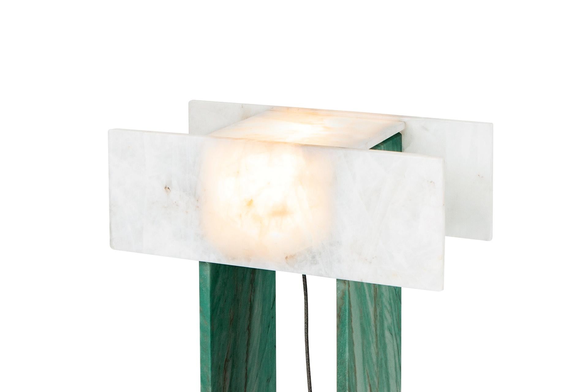 This is Pedrita floor lamp (Model S) and it is part of Pedrita lamp series.
This floor lamp is made of a translucent quartz and green quartzite. 

Pedrita lamp series’ concept is based on an experimentation of Brazilian stones: quartzites and quartz