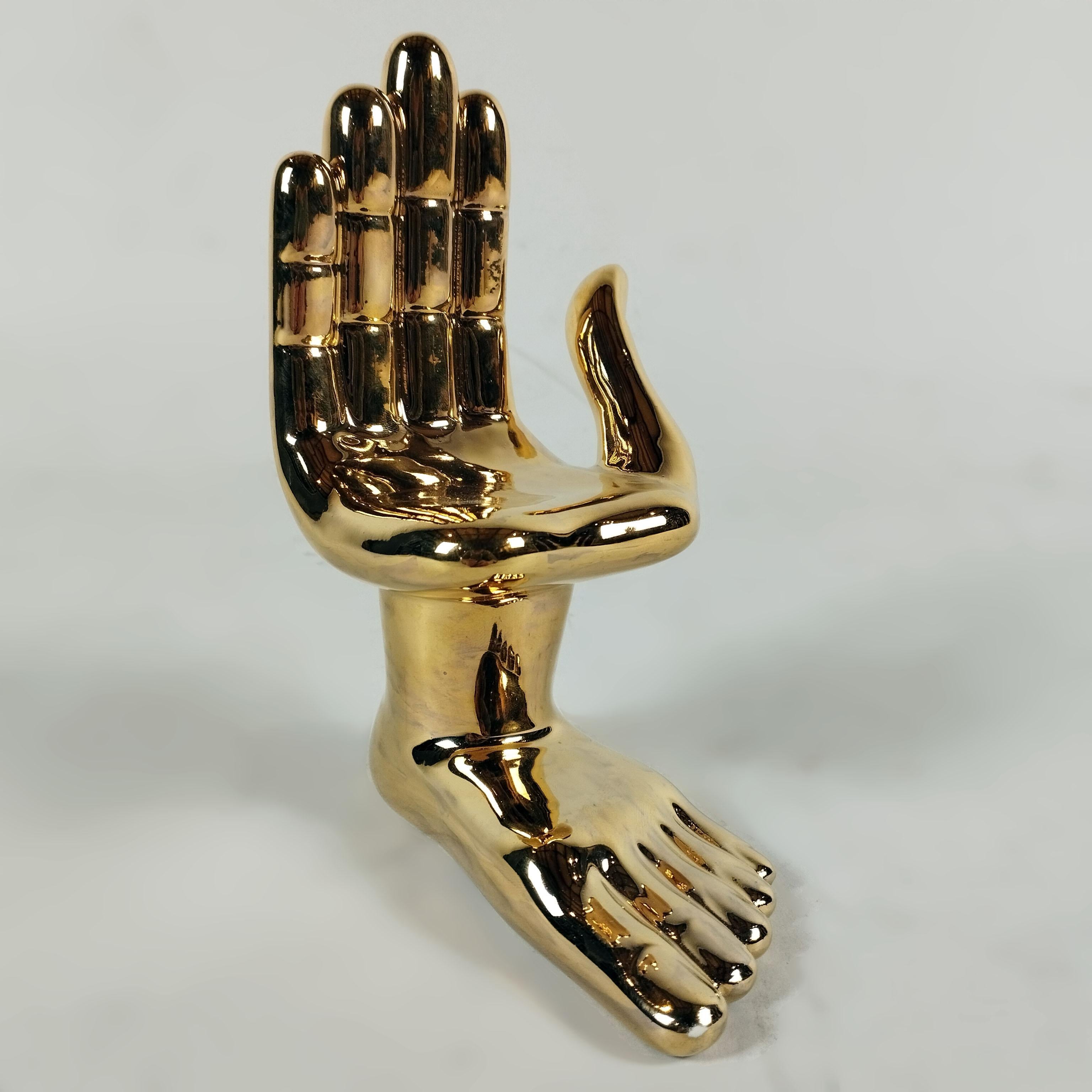 A ceramic with 22K liquid gold hand - foot table sculpture by Mexican artist Pedro Friedeberg. The iconic sculpture is part of a small series of ceramics. Signed and numbered 07 on bottom. The sculpture also shows a PF intaglio seal.

Pedro