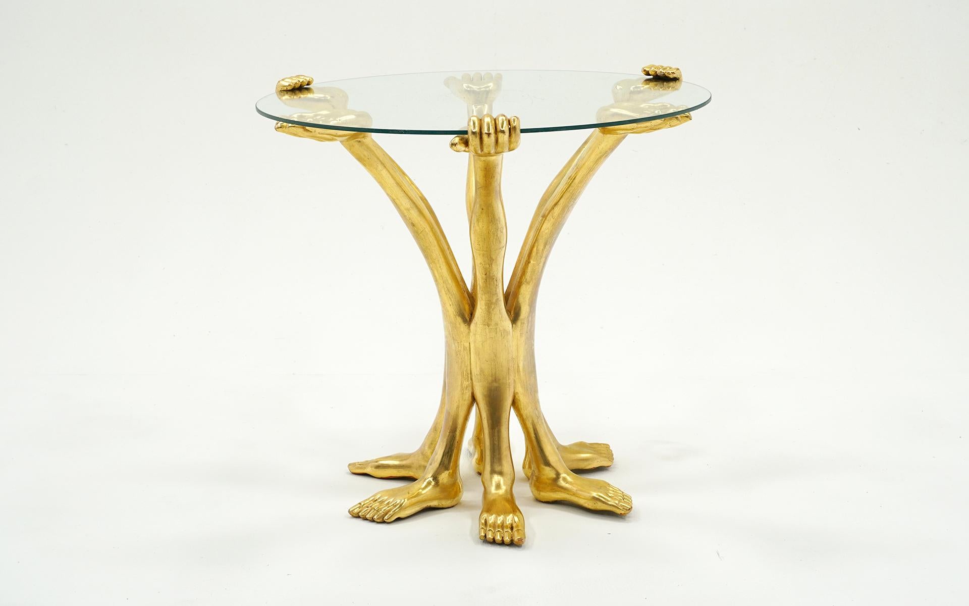 Beautiful Pedro Friedeberg side / end / occasional table.  Wood construction with gold leaf finish and original glass top.  One hand can be removed to remove the glass top.  Some losses to finish and light scratches but no distractions.  Ready to