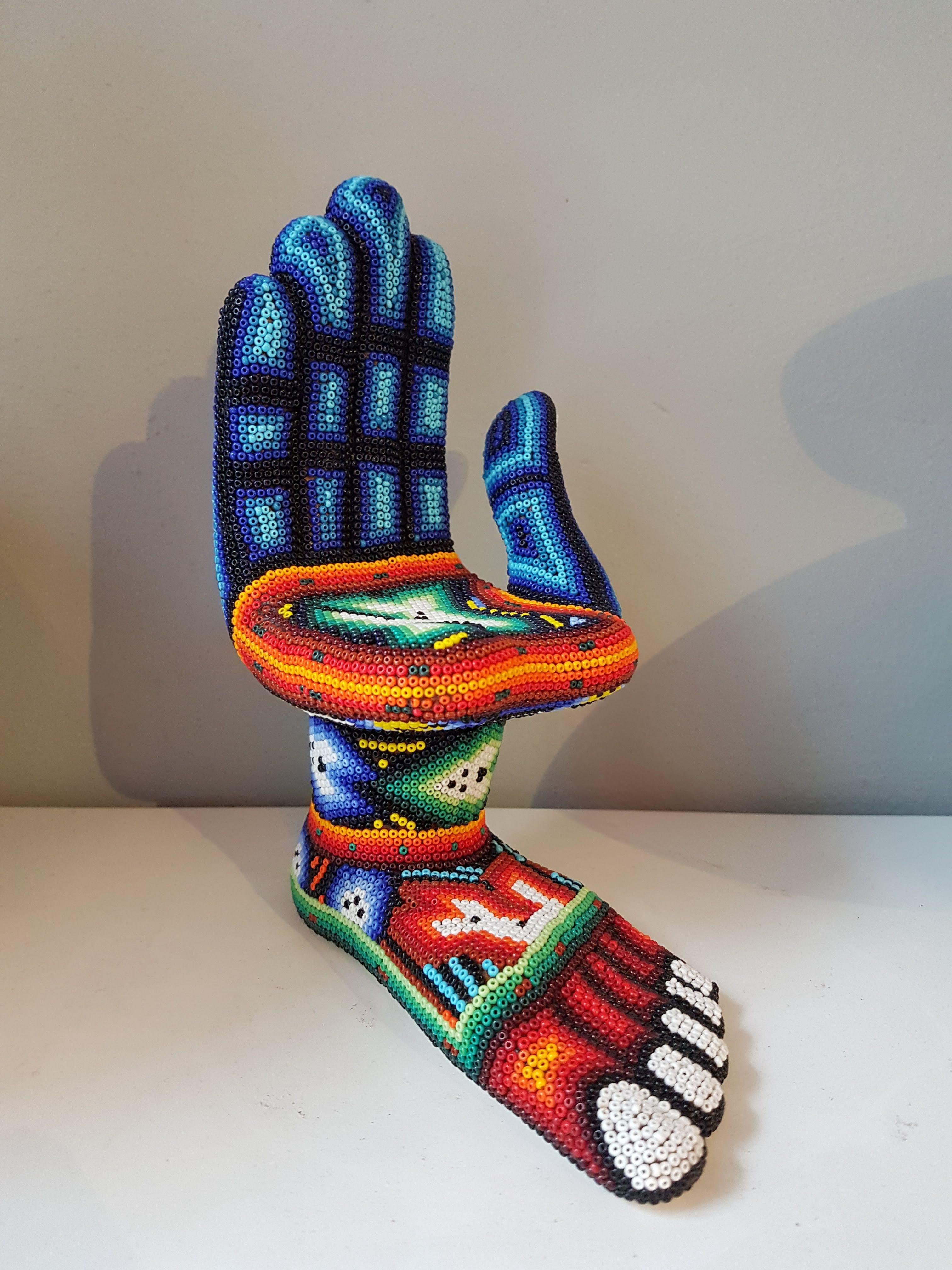 A hand - feet ceramic sculpture decorated with Huichol beadwork by Pedro Friedeberg. Signed on the bottom.

Pedro Friedeberg is a Mexican artist and designer known by his surrealist work filled with lines and colors, as well as ancient and