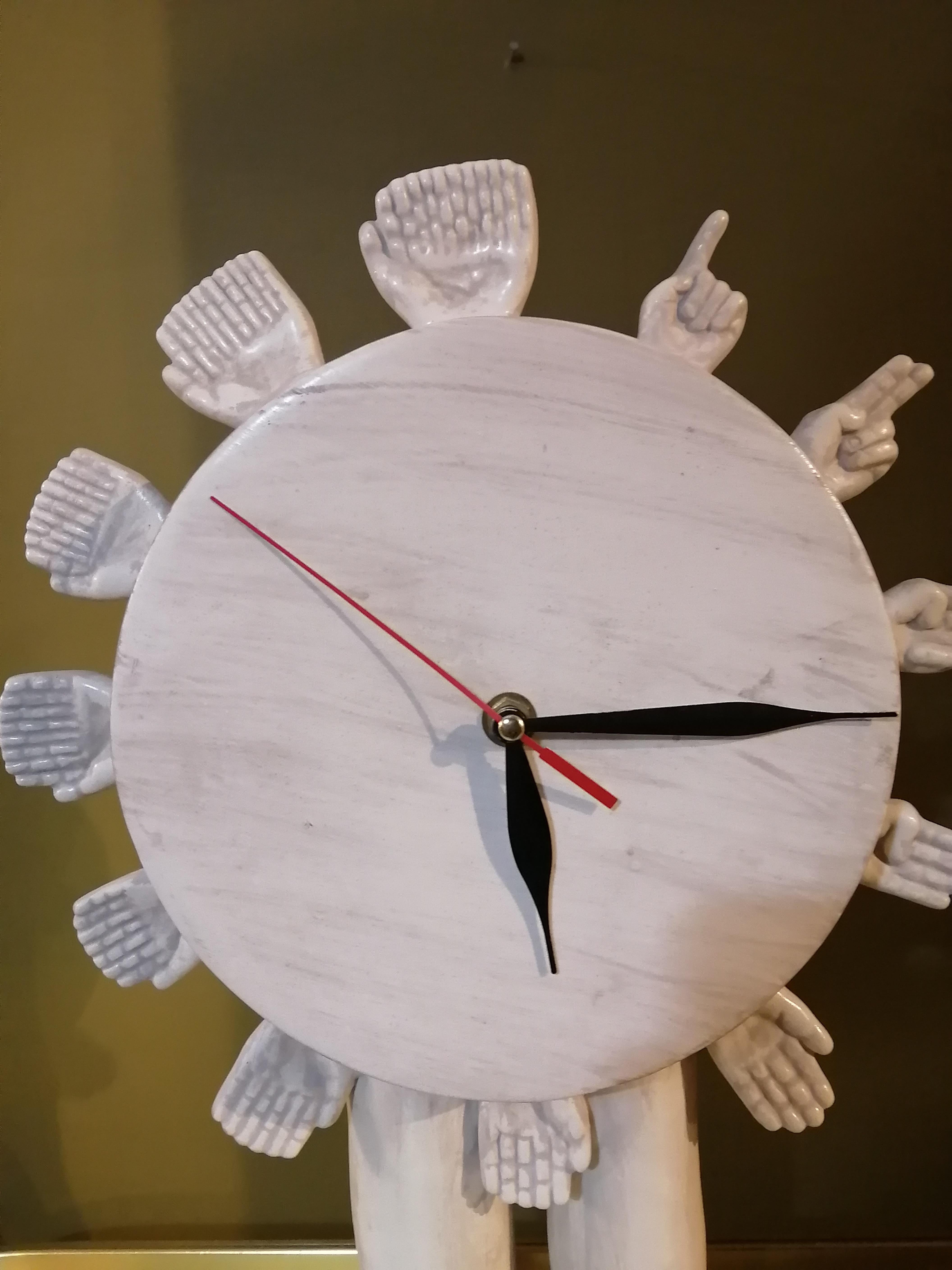 A surrealistic sculptural clock made in ceramic by Mexican artist Pedro Friedeberg. The clock's ceramic body has a marble finish. The clock's mechanism is a regular quartz movement for a AA battery. Signed on one of the legs.