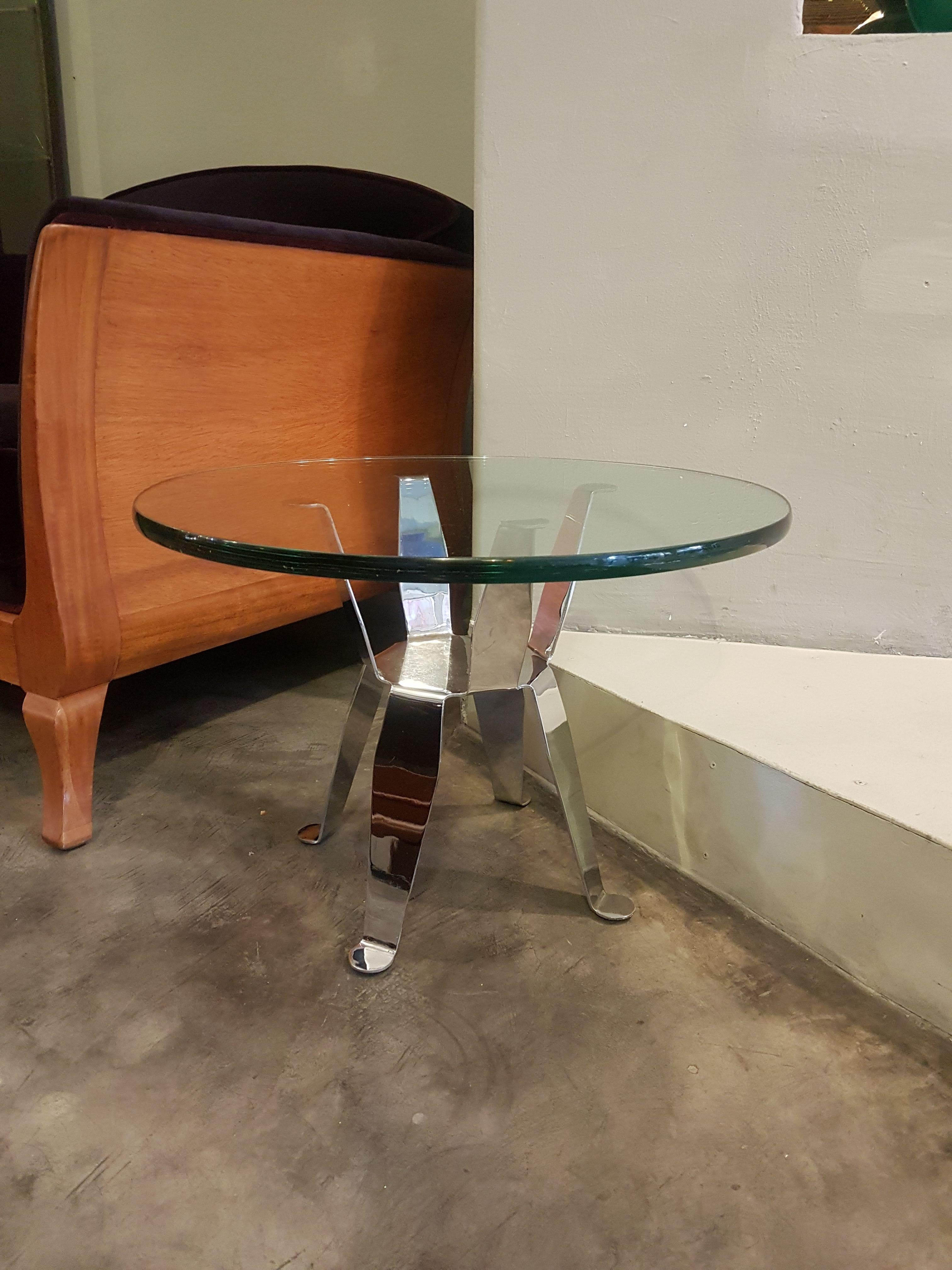 Important Pedro Ramírez Vázquez bent chromed steel side table with round glass top. 

Pedro Ramírez Vázquez is known as Mexico's most prominent architect. His work includes some of the country's architectural highlights from the second half of the
