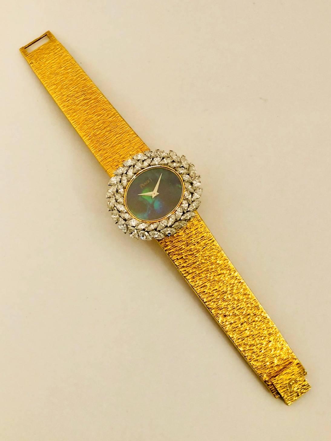 Since 1874, Piaget has designed, developed and produced world class timepieces.  This 18 karat yellow gold watch features a hypnotic black opal face.  Case measures 32mm x 29mm.  A laurel wreath of marquise white diamonds, set in 18 karat white