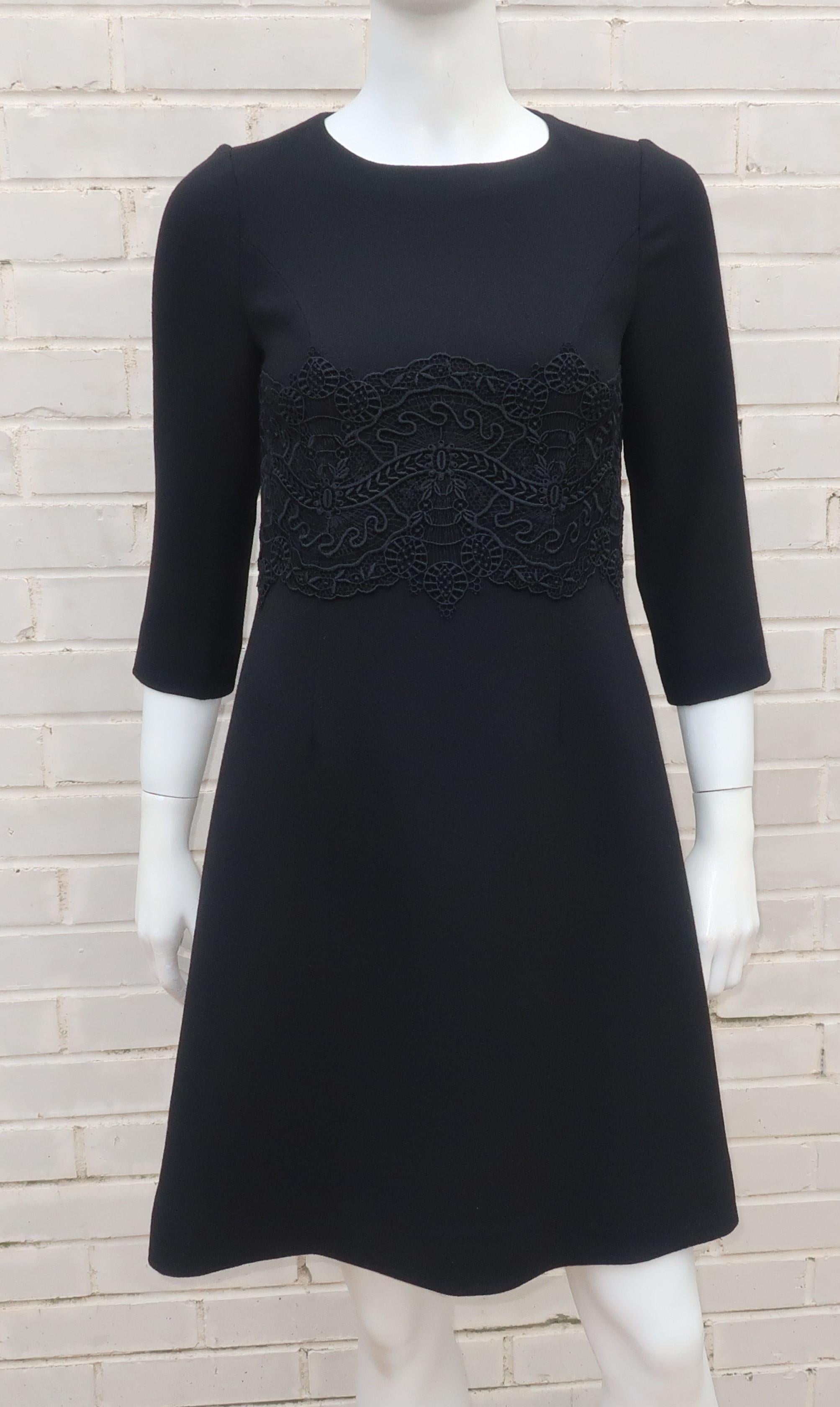 A modern twist on the 'little black dress' by a designer of ultra feminine styles, Peggy Jennings.  Ms. Jennings designs often include antique and handmade lace ... indeed this simple wool crepe a-line silhouette is beautifully accented by black