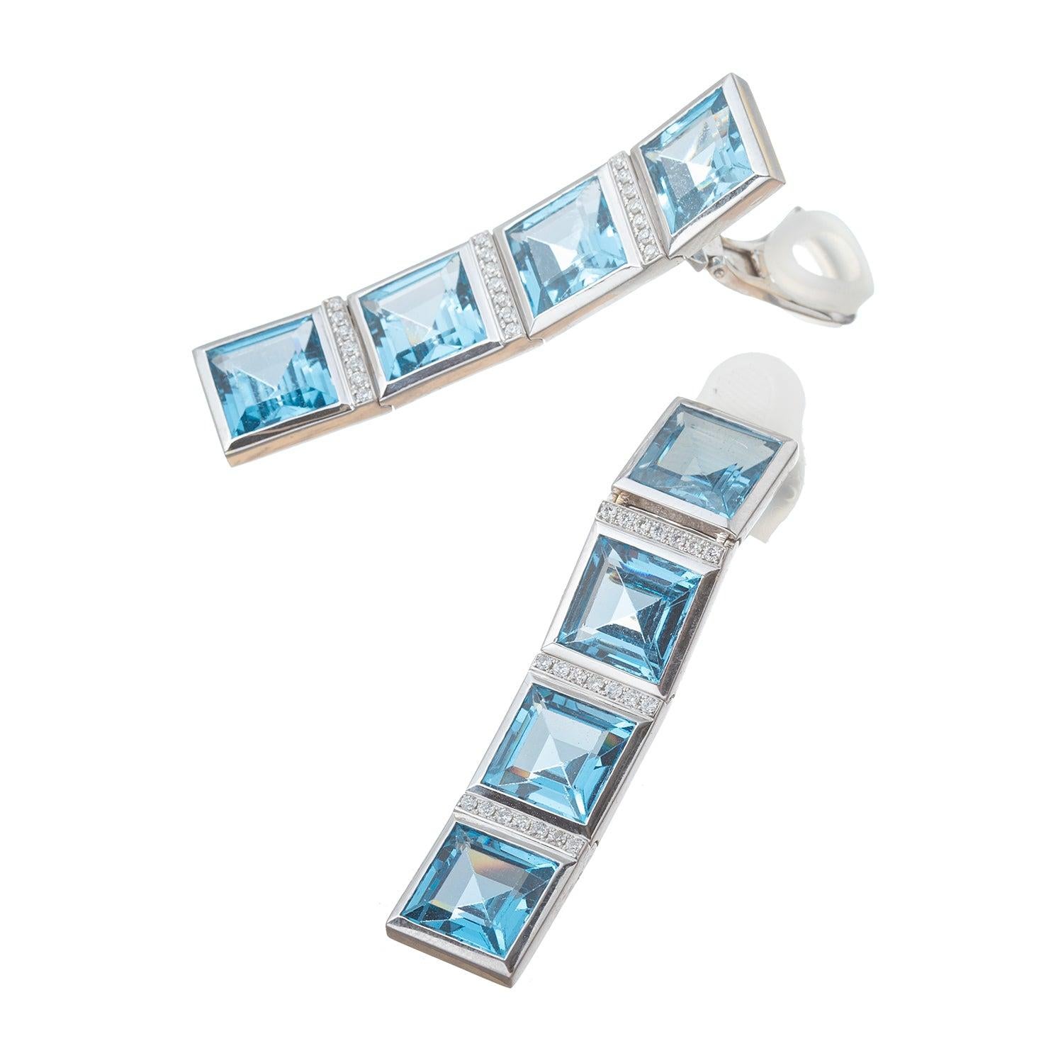 Drop earrings in 18k white gold, each featuring four square-cut blue topaz separated by rows of round-cut diamonds.  Clip backs (posts may be added upon customer request).  2.25