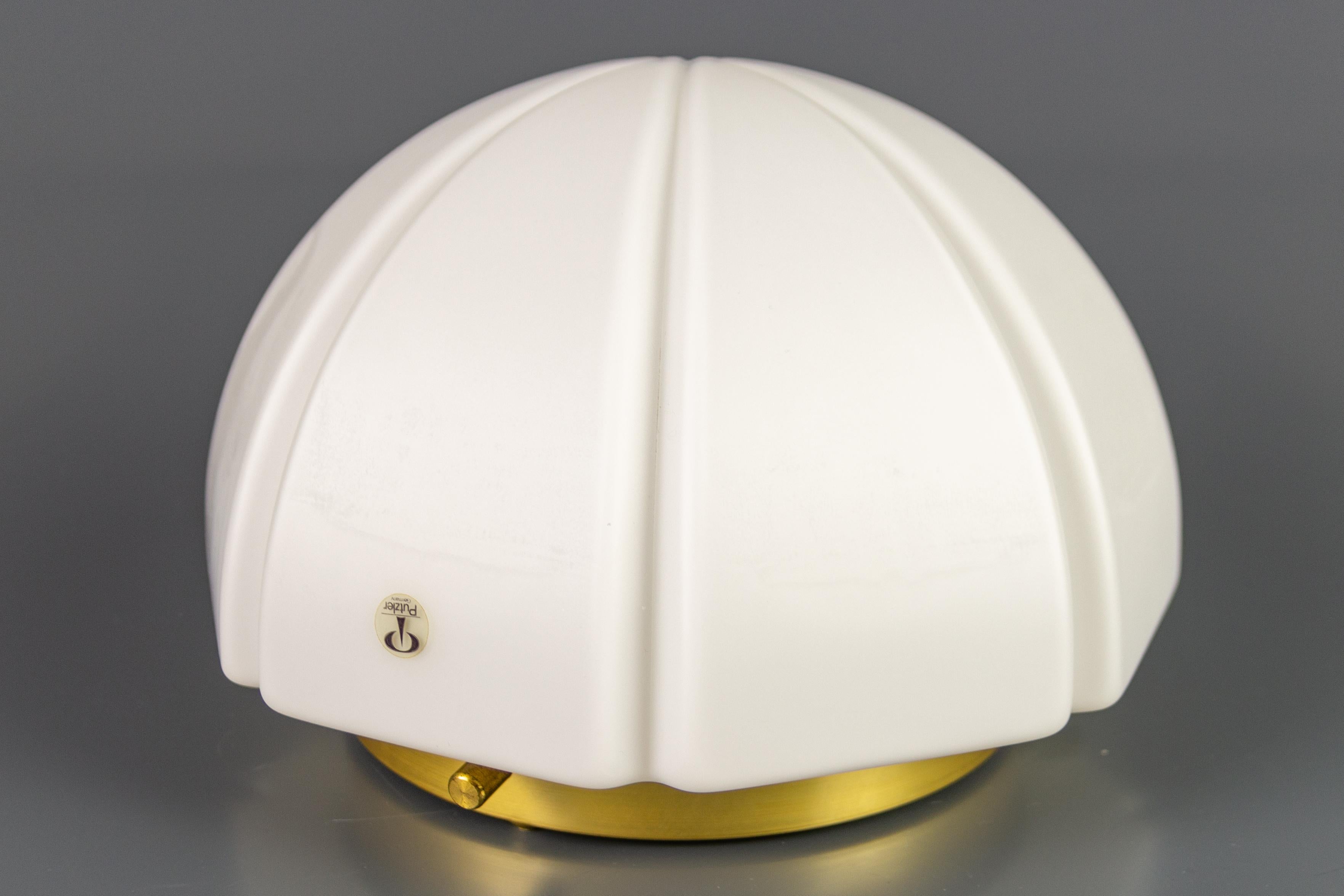 Elegant flush mount or ceiling light by Peill & Putzler, Germany, 1970s. The ceiling light features a round brass ceiling mount and a beautiful lightly pearlized white glass shade.
Timeless design, rare model, and high quality.
Dimensions: height: