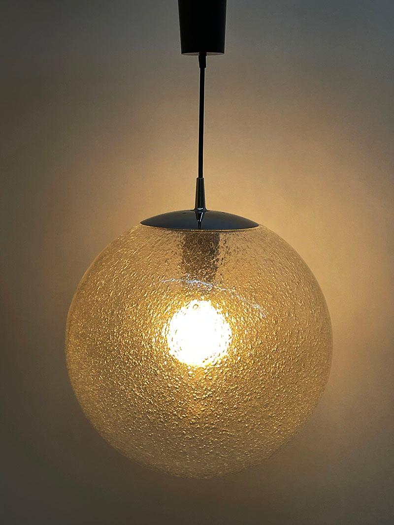 Peill & Putzler 1970s large Bubble ball pendant lamp

A pendant lamp by Peill & Putzler, Germany 1970s. A hand blown glass in the shape of a round ball with air bubbles and chromed metal. Inside of the metal suspension system it is marked with a