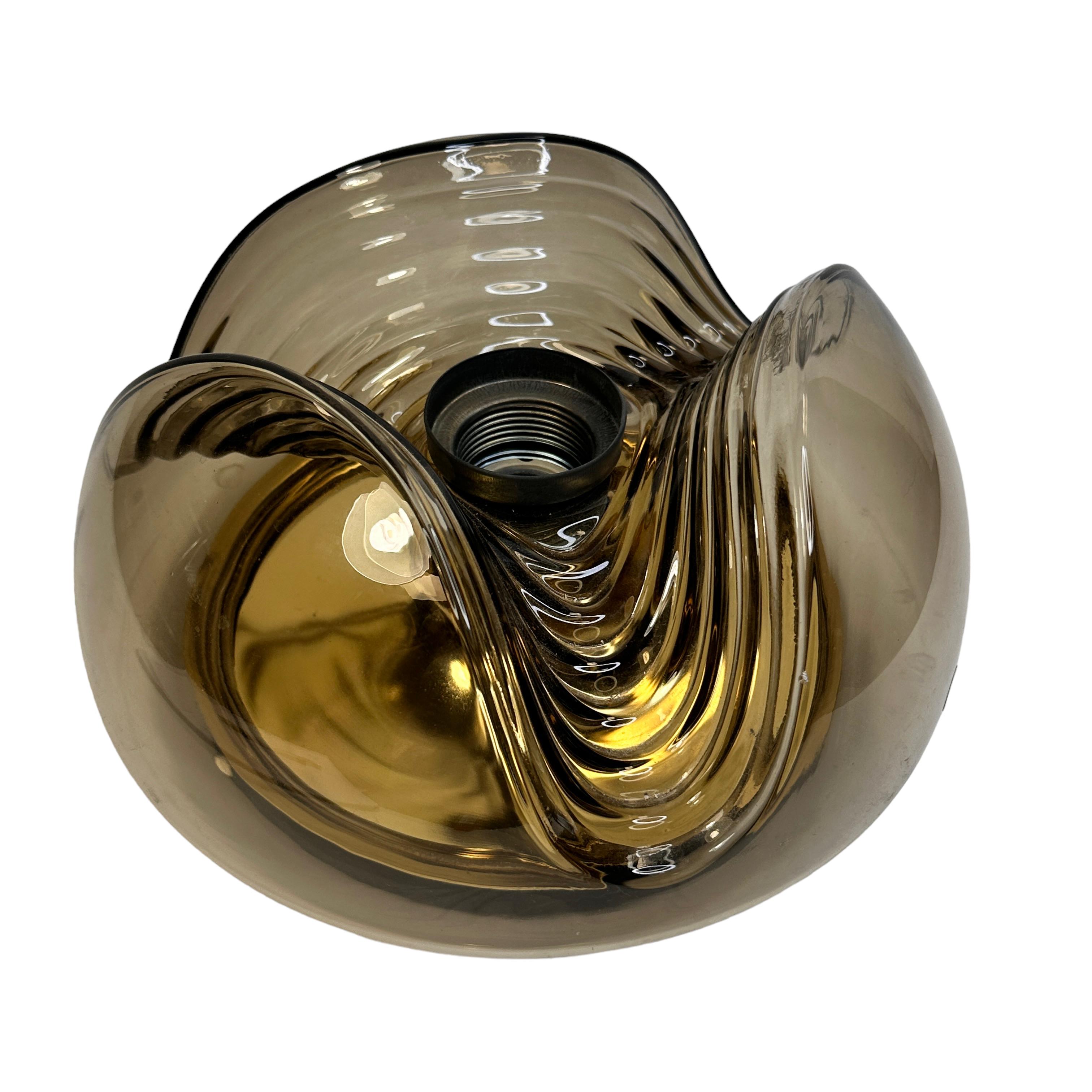 A nice Peill & Putzler amber glass wave Flush mount or sconce / wall light. Made by Peill and Putzler Germany, design by Koch and Lowy. The fixture requires one European E27 Edison bulb, up to 100 watts. A nice addition to any room. Found at an