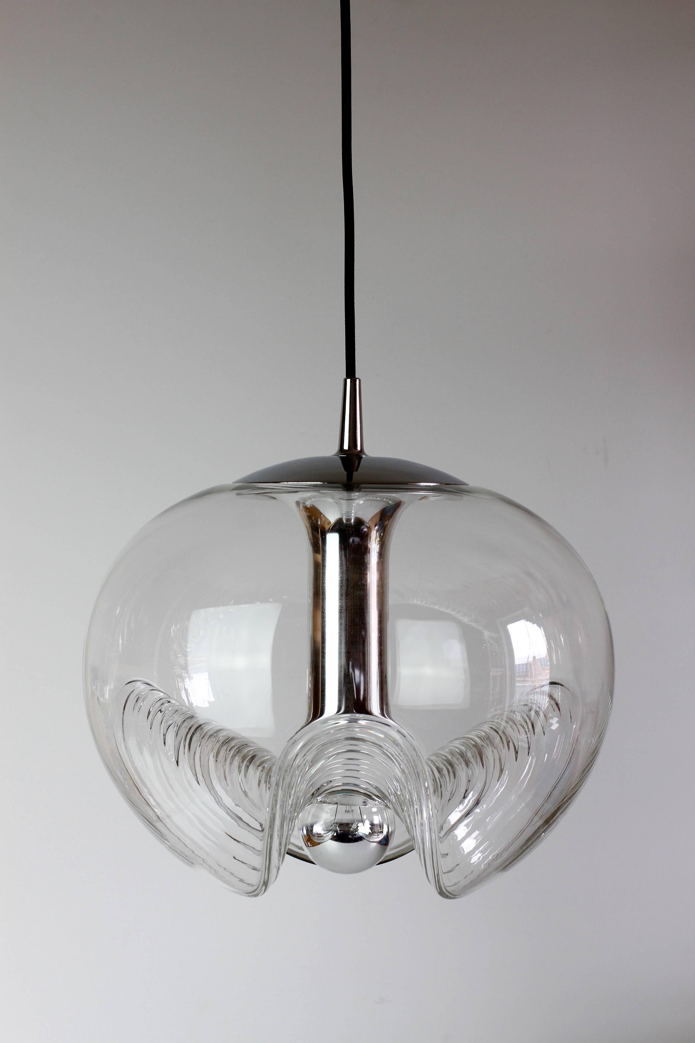 Single beautiful midcentury pendant light design by Peill & Putzler in the 1970s. This is an absolutely Classic piece of design, featuring a clear glass globe shade with a waved or ribbed molded bubble form, casting a beautiful rippled light. 

This