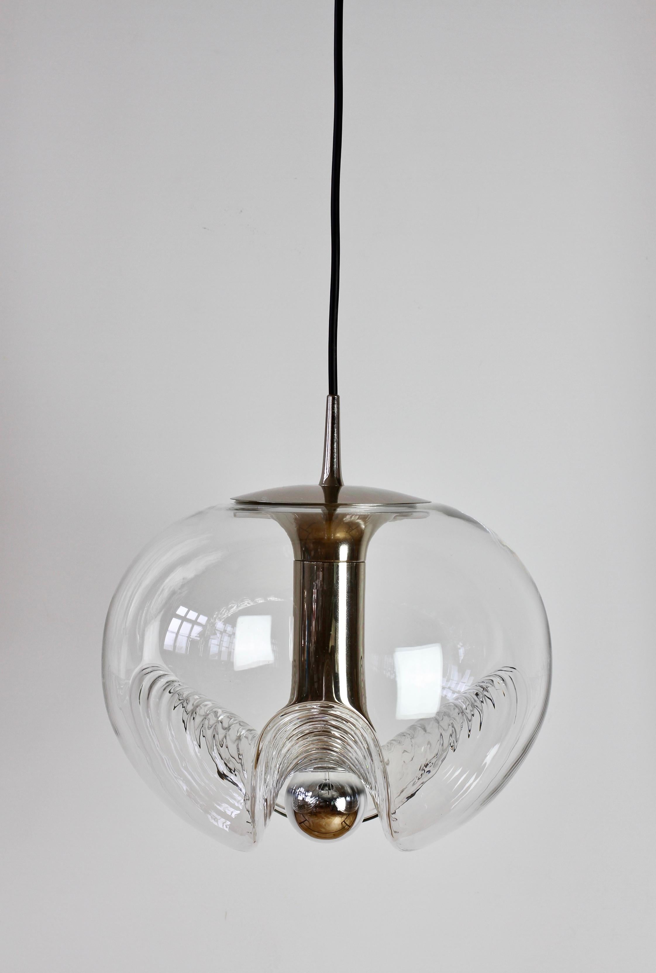 Belle lampe pendante du milieu du siècle par Peill & Putzler dans les années 1970. Il s'agit d'une pièce de design absolument classique, avec un abat-jour en verre transparent et une forme de bulle moulée ondulée ou nervurée, qui projette une belle