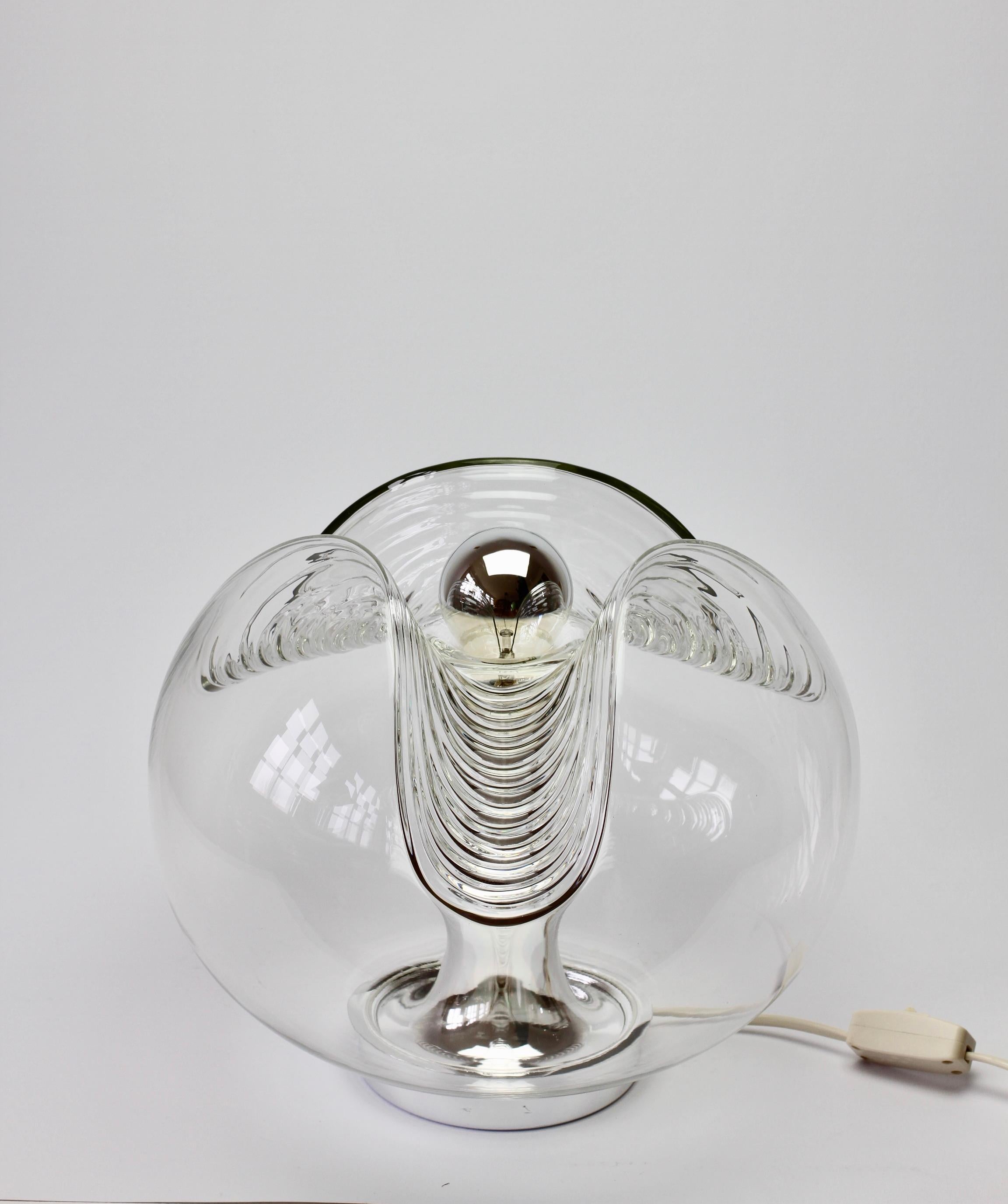 Midcentury vintage table lamp or light by German manufacturer Peill & Putzler in the 1970s. This is an absolutely Classic piece of design, featuring an organic and biomorphic shaped clear glass globe shade with a waved or ribbed moulded bubble form