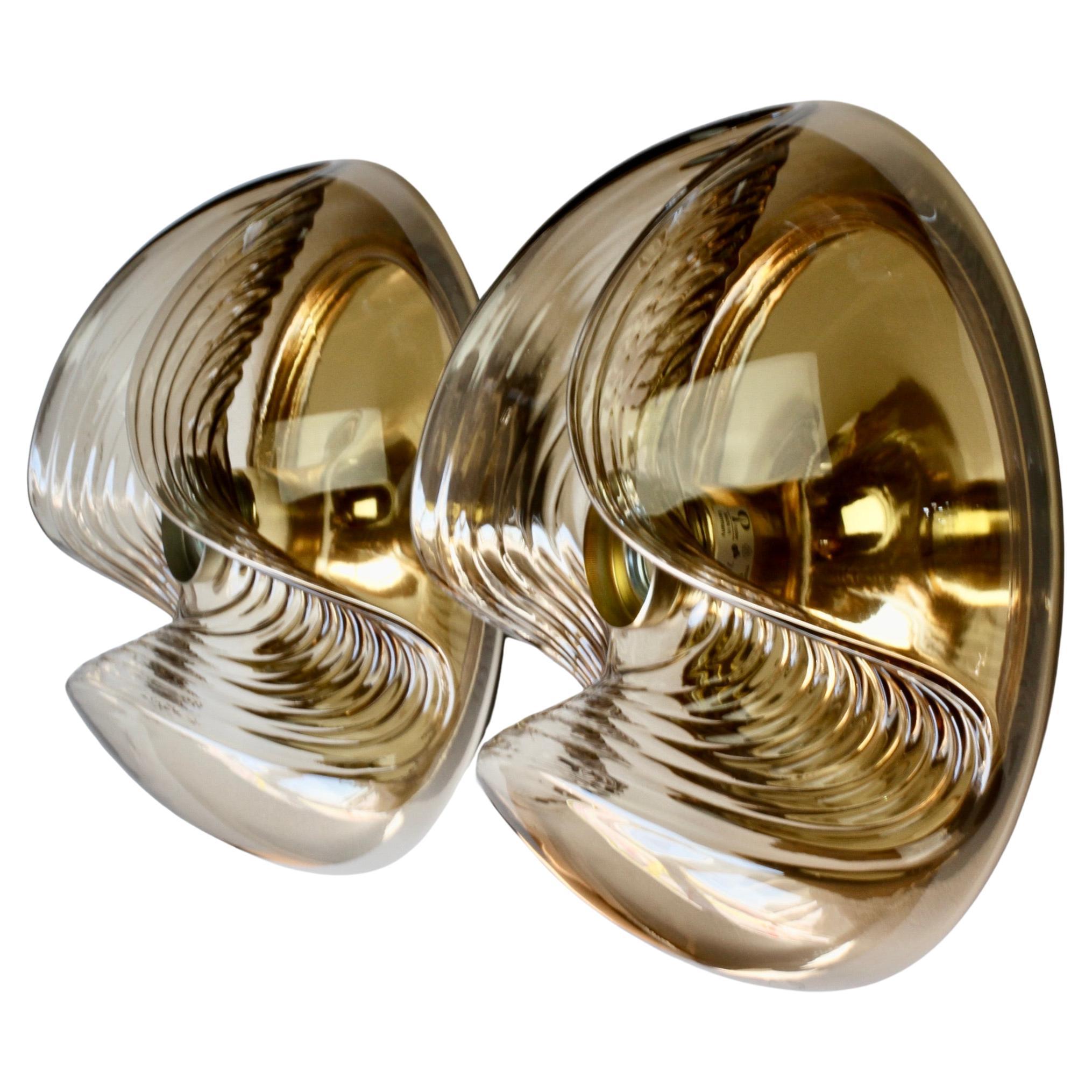 Large pair of mid-century 'Futura' or commonly referred to as 'Wave' flush mount ceiling or wall lights / sconces by Peill & Putzler in the 1970s. This is an absolutely Classic piece of design, featuring a smoked coloured (colored) glass globe shade