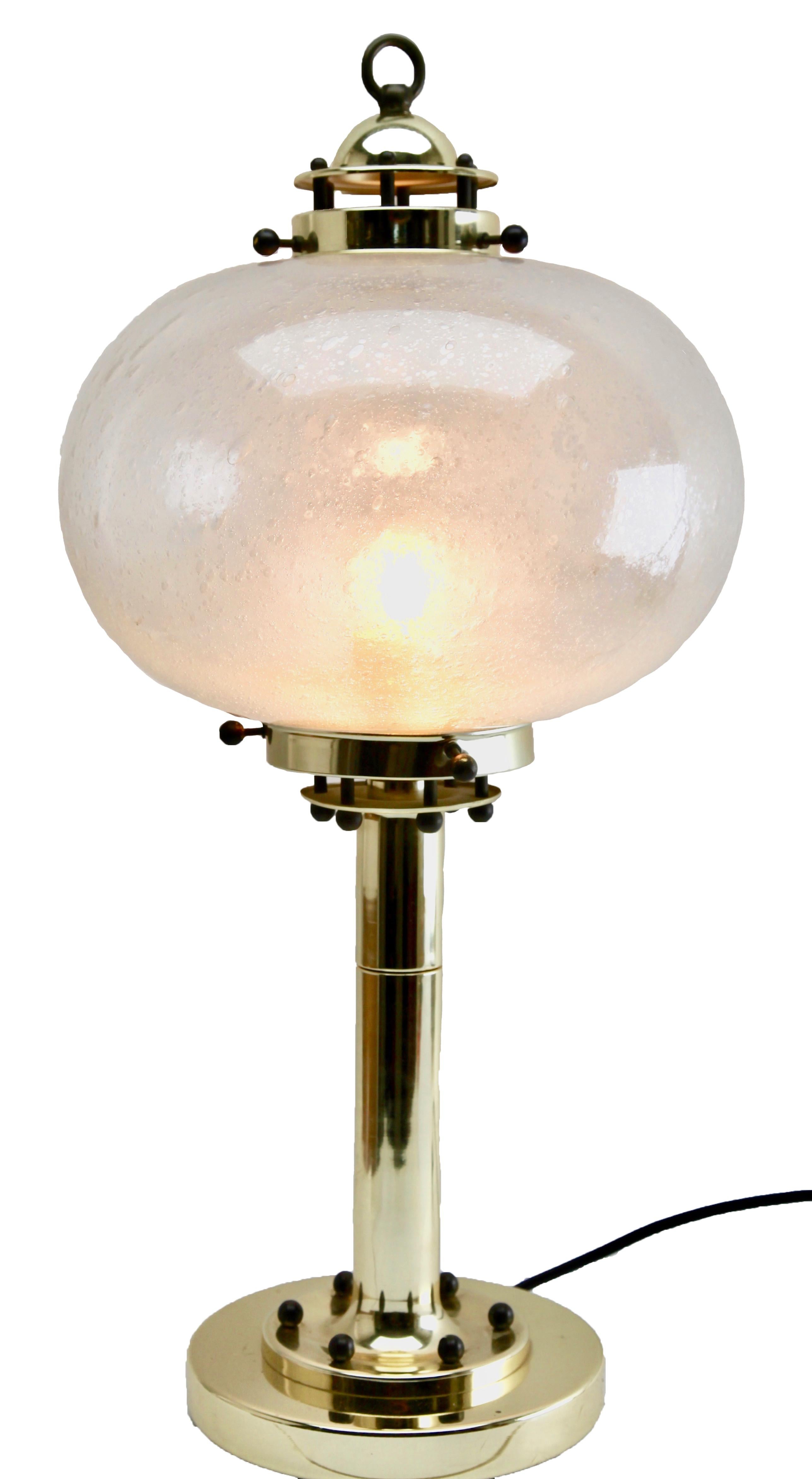 Mid-Century Modernist German 1960s table lamp by Peill & Putzler

Mid-Century Modernist German 1960s lamps were designed by Peill & Putzler. They feature a globular glass lampshade with brass fittings and are made of hand blown glass giving a