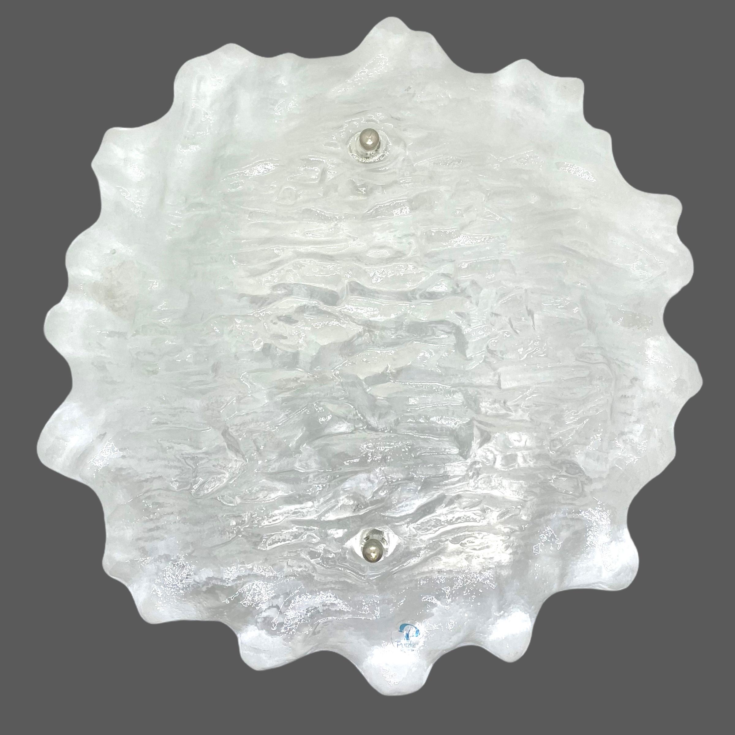 A beautiful wall light or sconces made by Peill & Putzler, circa 1970s, in very good original condition. The frosted ice glass with swirl pattern is composed of a metal frame and with two lights. The fixture requires two European E14 / 110 Volt
