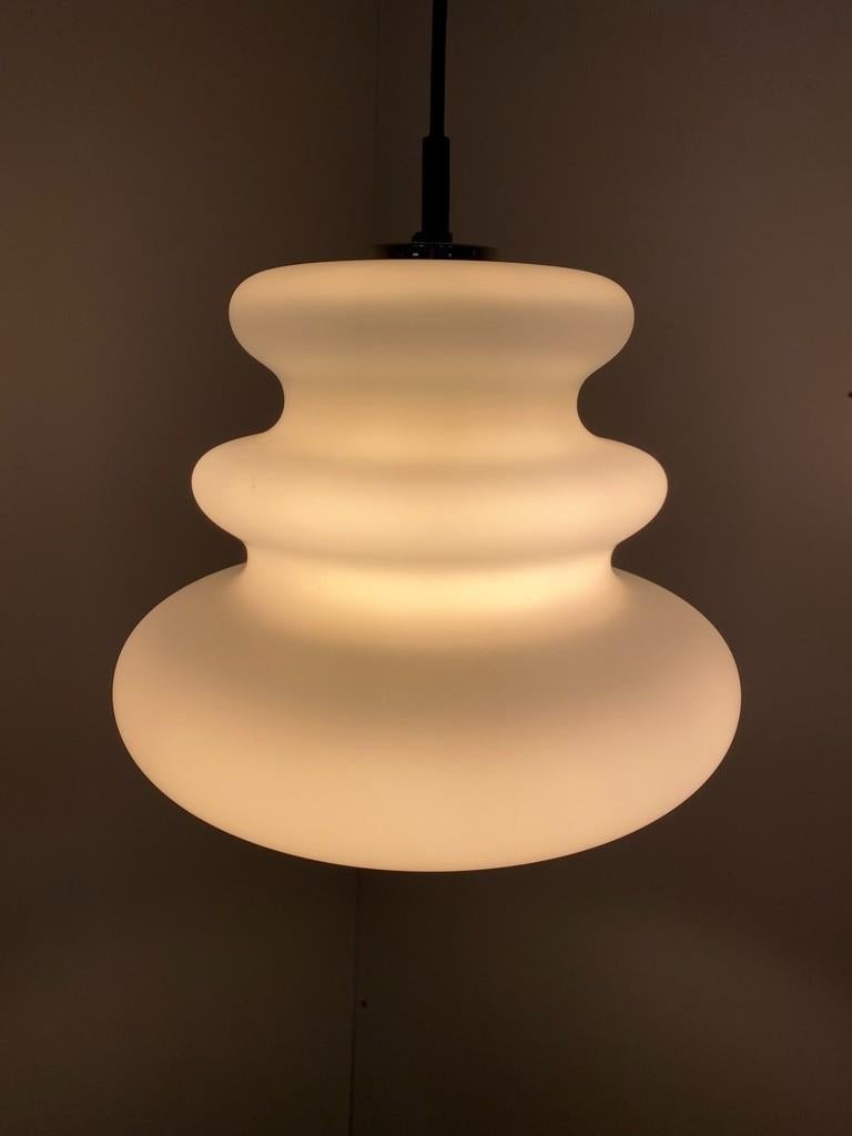 Atmospheric Peill and Putzler pendant lamp. Peill and Putzler lamps are high quality designed and manufactured lamps. This one is a great example. The lamp is made of a single piece of organically shaped, frosted opaline glass. Both off and on, this