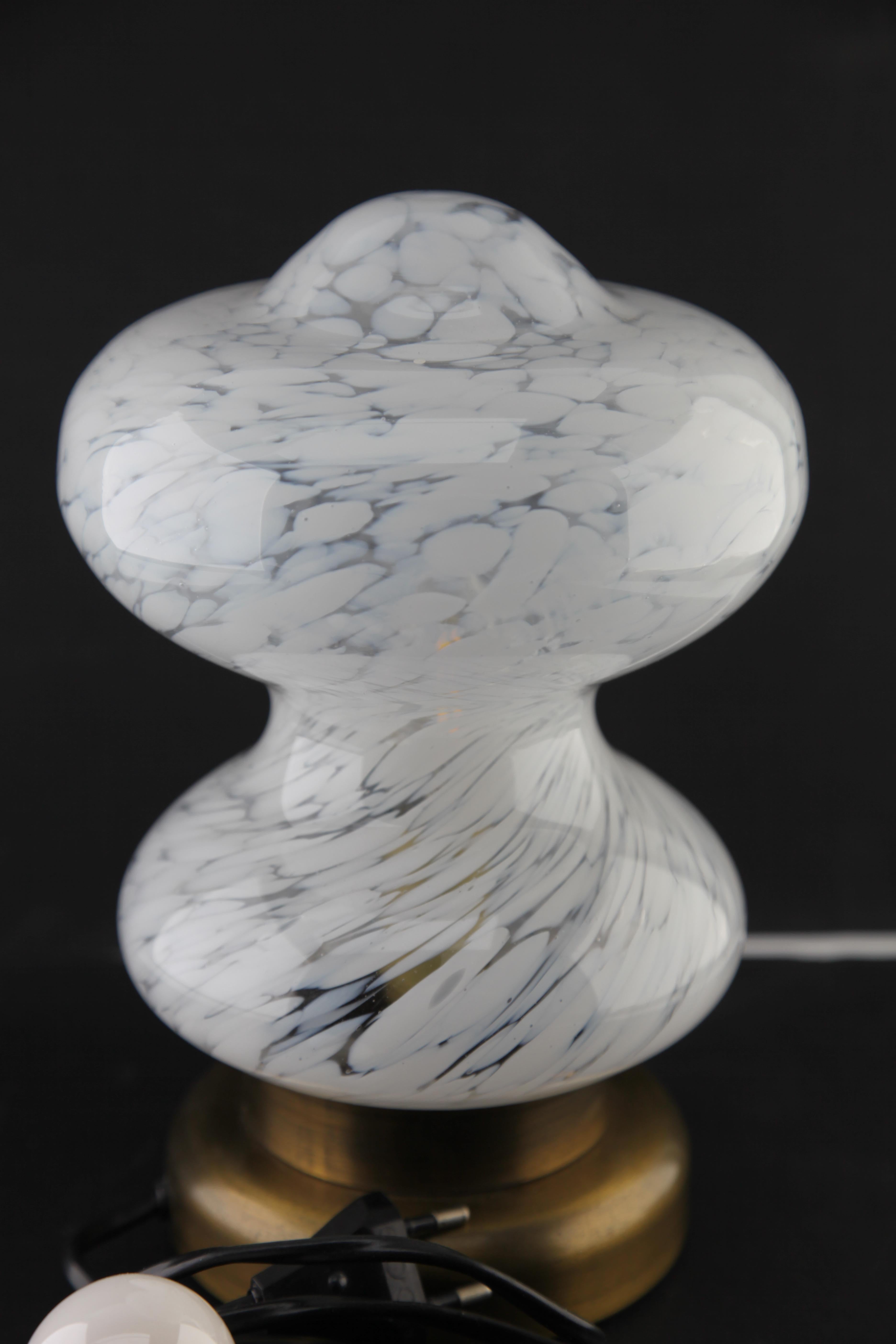 Hollow-footed glass table lamp made by Peill & Putzler in the 1970s. Their unique patterning awareness of light patterns and their use of frosted glass to give a range of white shades was typical of Peill & Putzler's design ethic, focusing on both