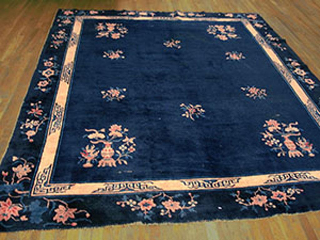 Peking carpets are almost invariably Chinese in their decorative style, as here, with vases on stands, seasonal flowers, fretwork border elements, more paeonies in the border, and blue, blue, blue. Peking loves blue in all its tints, shades, hues