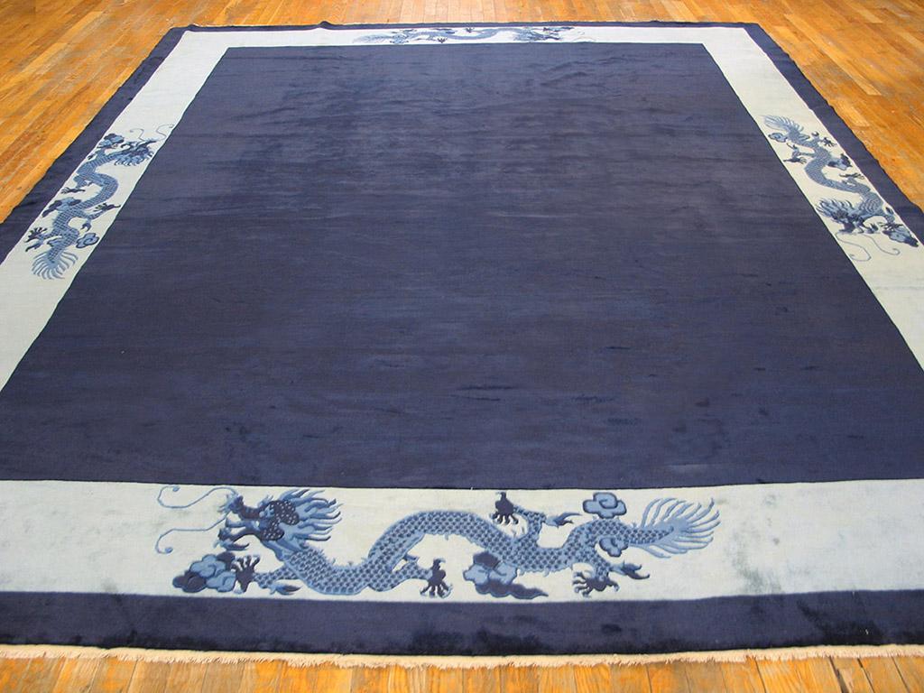 Although modern, circa 1960, this carpet it has none of the technical or stylistic excesses of so many tour de force pieces of this period. It is all about blue. The navy field is absolutely plain. The light blue border has four striding dragons