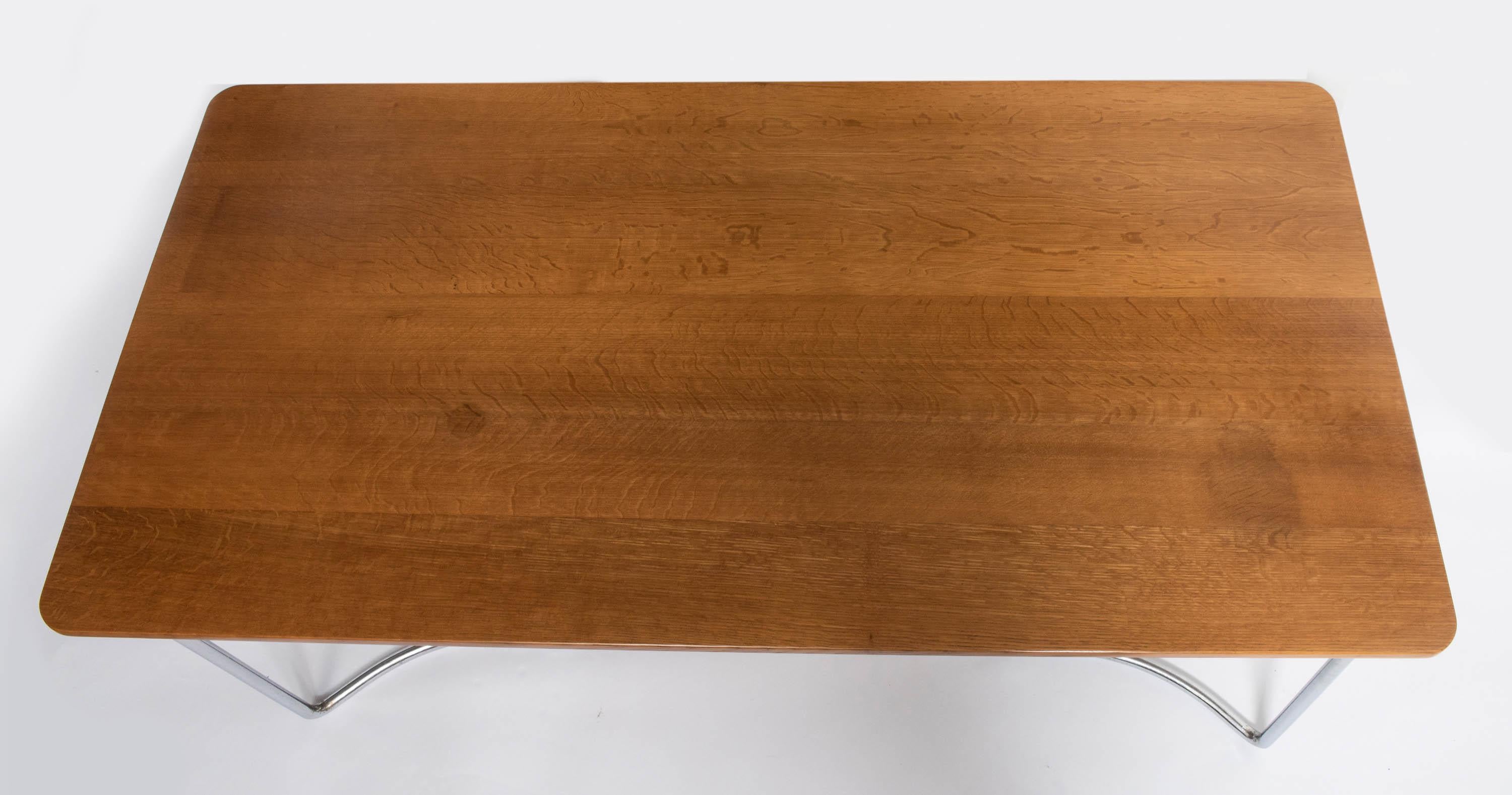 A rare P.E.L (Practical Equipment Limited) British modernist dining table.
Model no. HT11.
Designed by the designer/ architect Oliver Bernard.
Oak veneered plywood top of rectangular shape.
Raised on tubular chrome-plated steel frame.
England,
