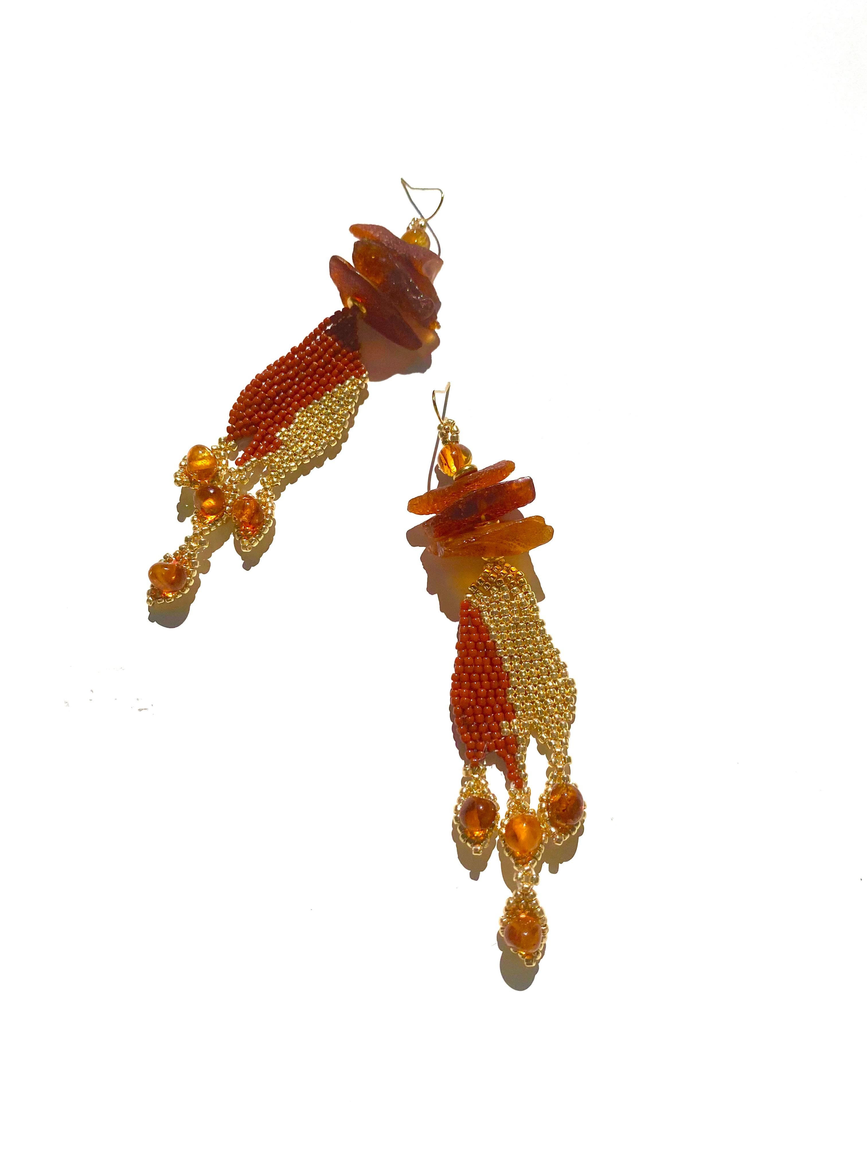 Handwoven in a shape of flames, permanent 14k gold-plated and marron Japanese seed beads, with large Baltic Amber chips and beads.

Pele is inspired by the goddess of volcanic fire, who is also referred to as She Who Shapes the Sacred Land. She's a