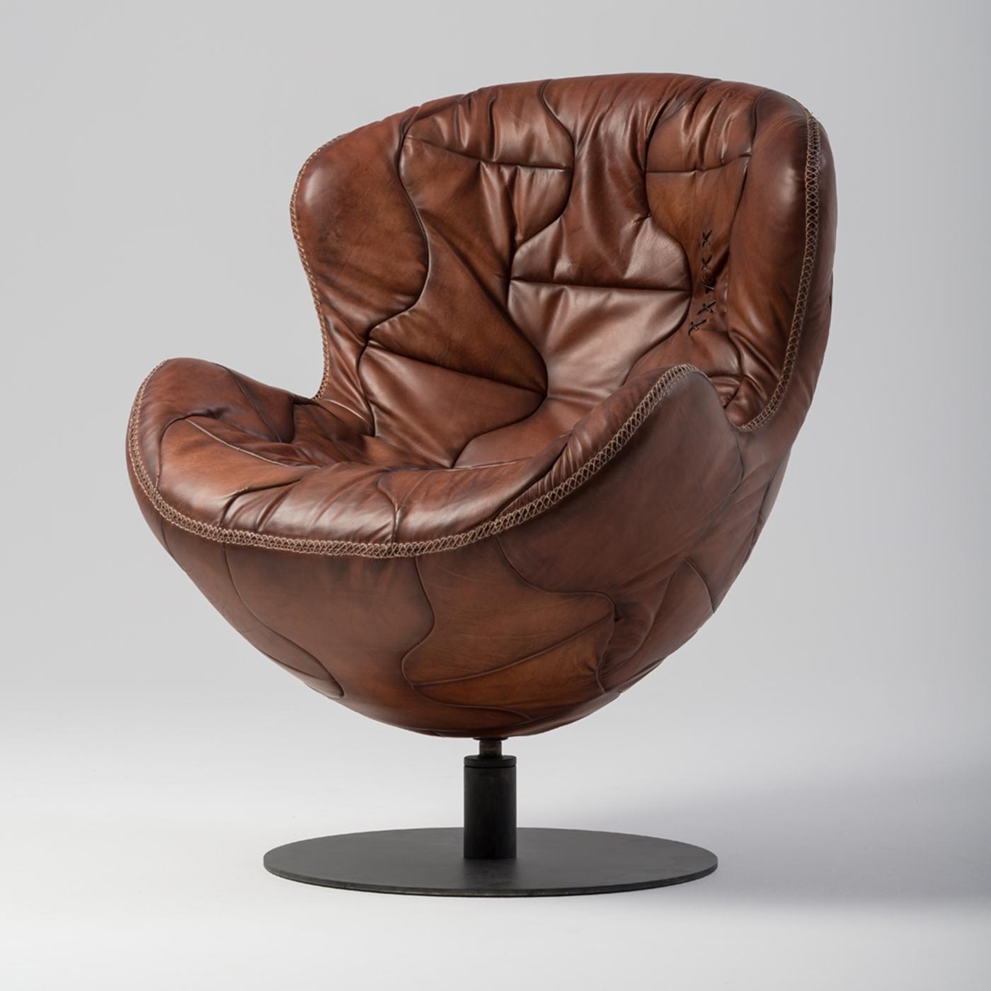 The handmade Pelè armchair is crafted with the same manufacturing techniques of ancient soccer balls. Representing a tribute to the world famous footballer, it is made of crust leather, naturally tanned, hand-stitched and antiqued according to the