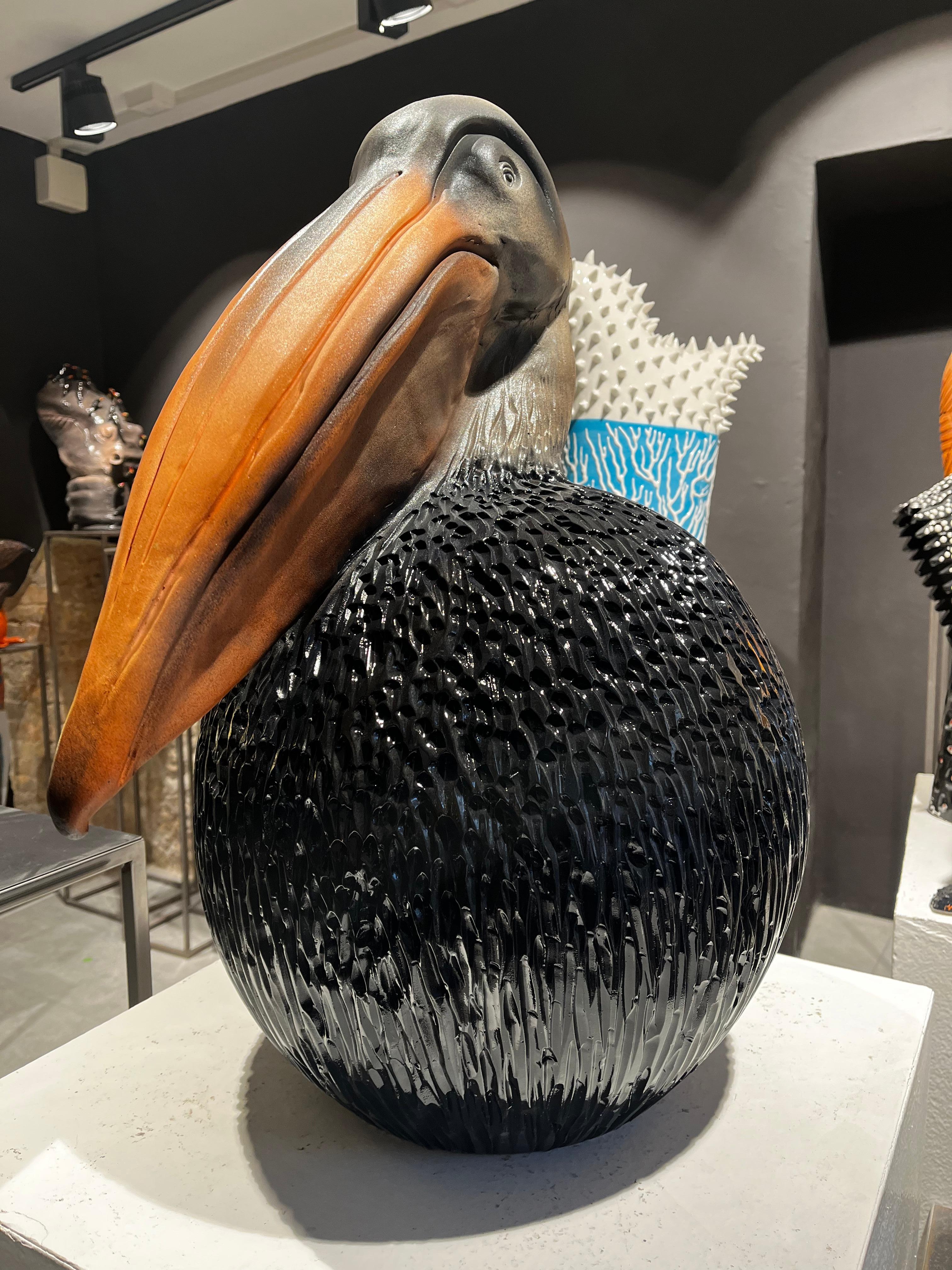 The piece is a unique representation of a Pelican in a modern way. The animal is gently painted with a brown color. 
Our designer creates these pieces completely by hand, without any mold. Any piece is different and created by the sapient hands of