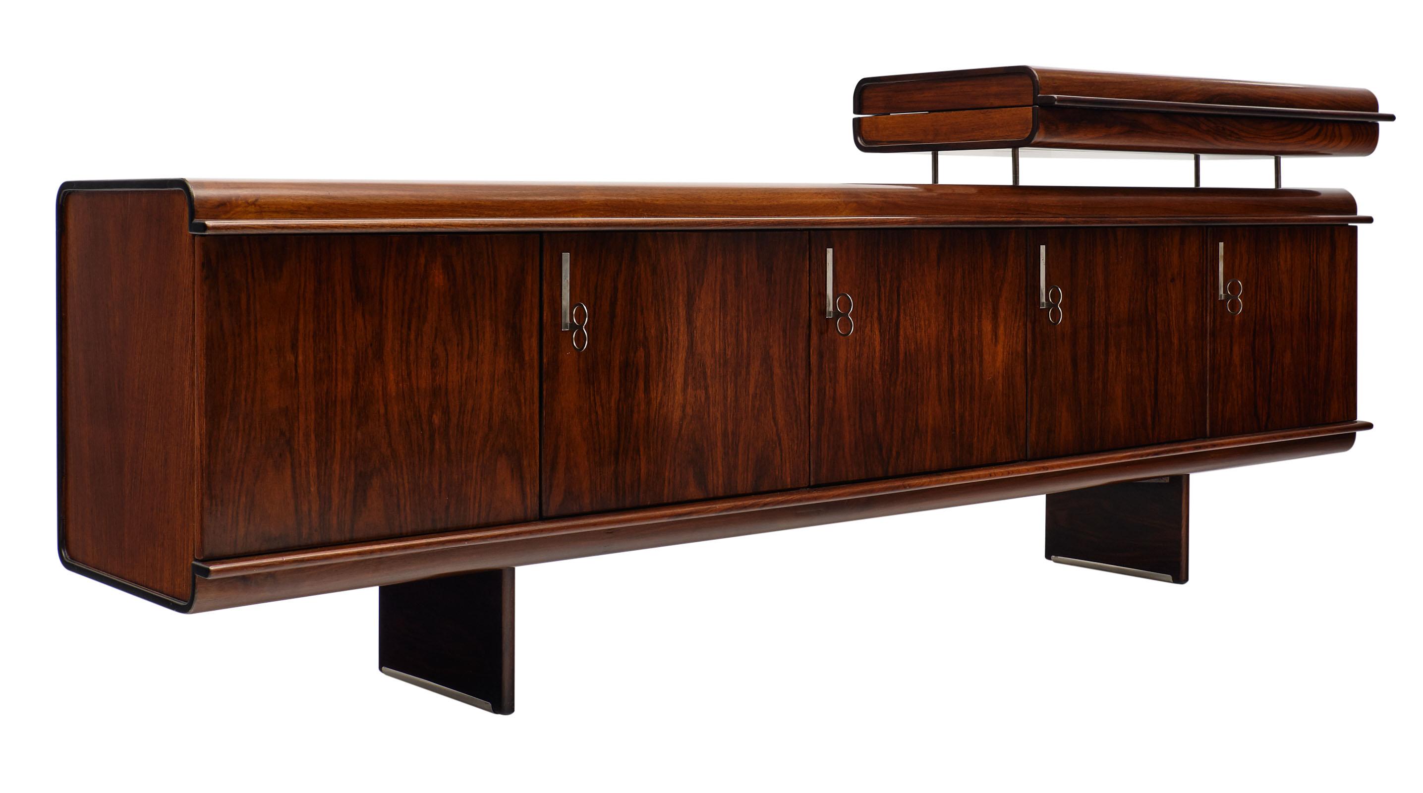 “Pellicano” buffet by Vittorio Introini for Saporiti. This stunning Italian piece is made of splendid, rich solid mahogany with a French polish finish. Chrome handles give it a polished look. We love the unique design and proportions of this superb
