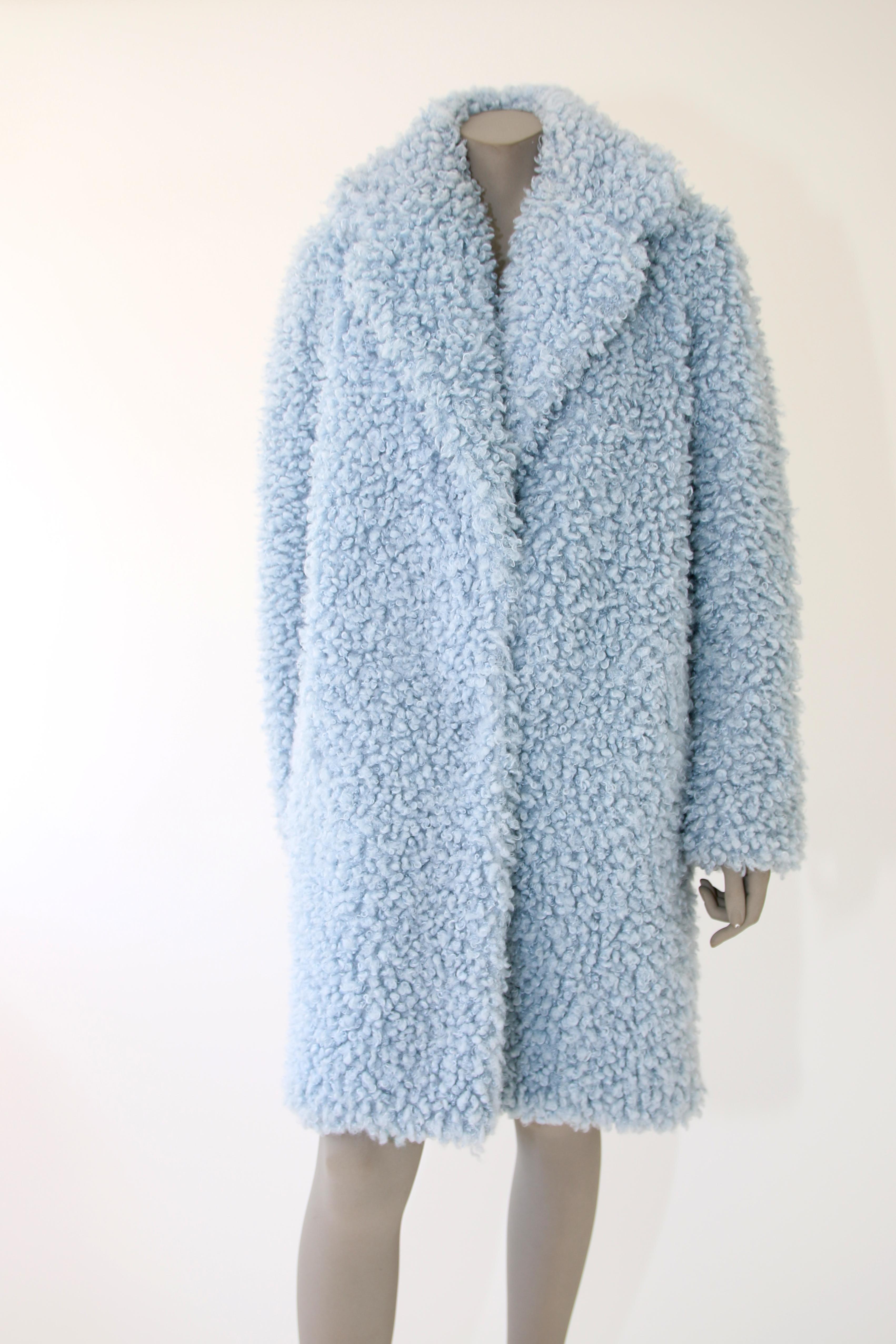 The Anna Pelush baby blue faux fur coat with collar is a one of a kind exclusive piece. Made with the highest quality man made pelage, this extra soft, lightweight cozy boucle' coat is a beautiful replica of a curly lamb fur. The etherial sky blue