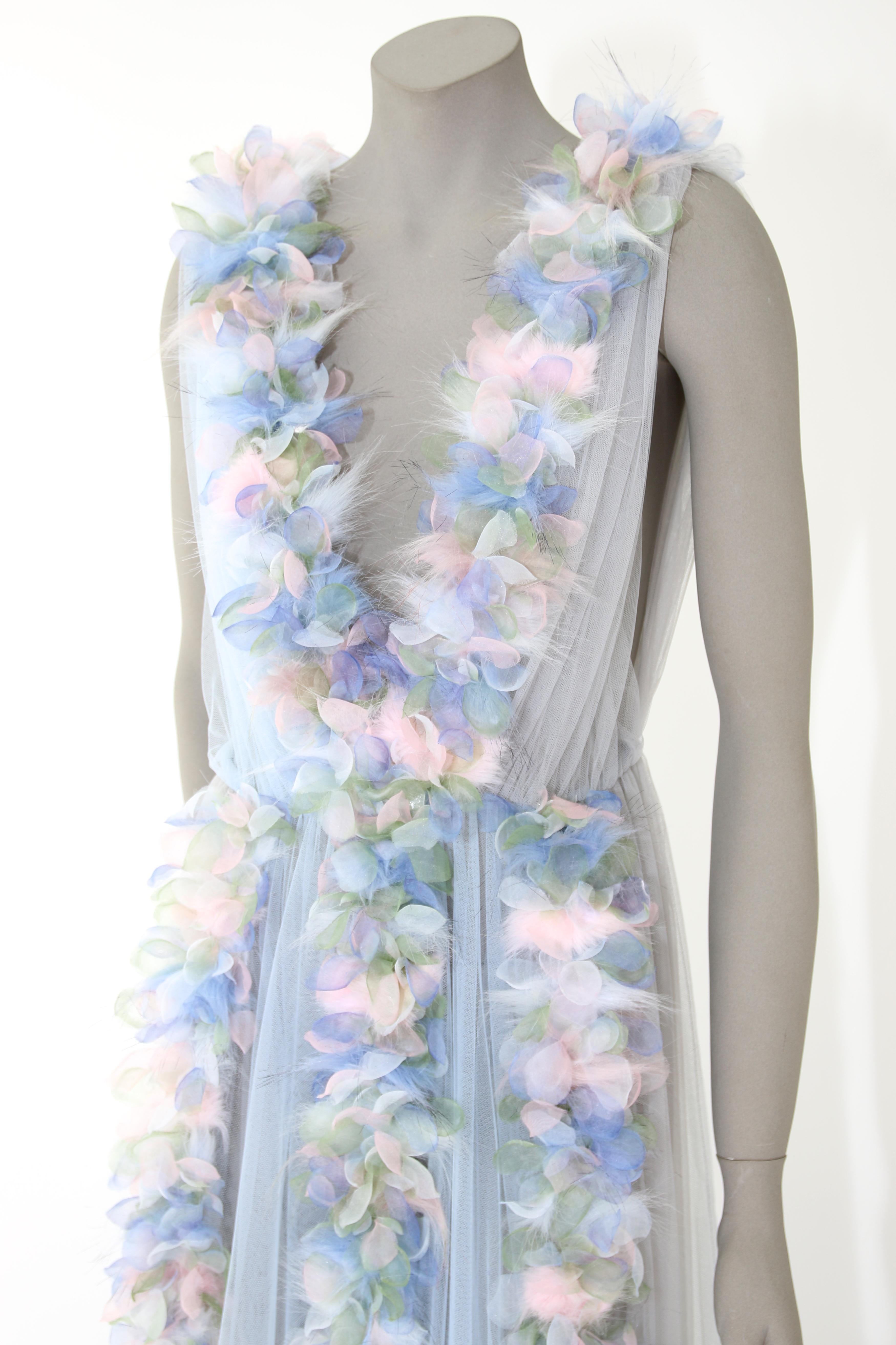 The Karina Pelush baby blue tulle dress gown with tridimensional flowers and faux feathers is a one of a kind exclusive piece. Adorned with romantic botanical tulle leaves in soft pastel colors and detailed with tiny inlay pieces of multi colored