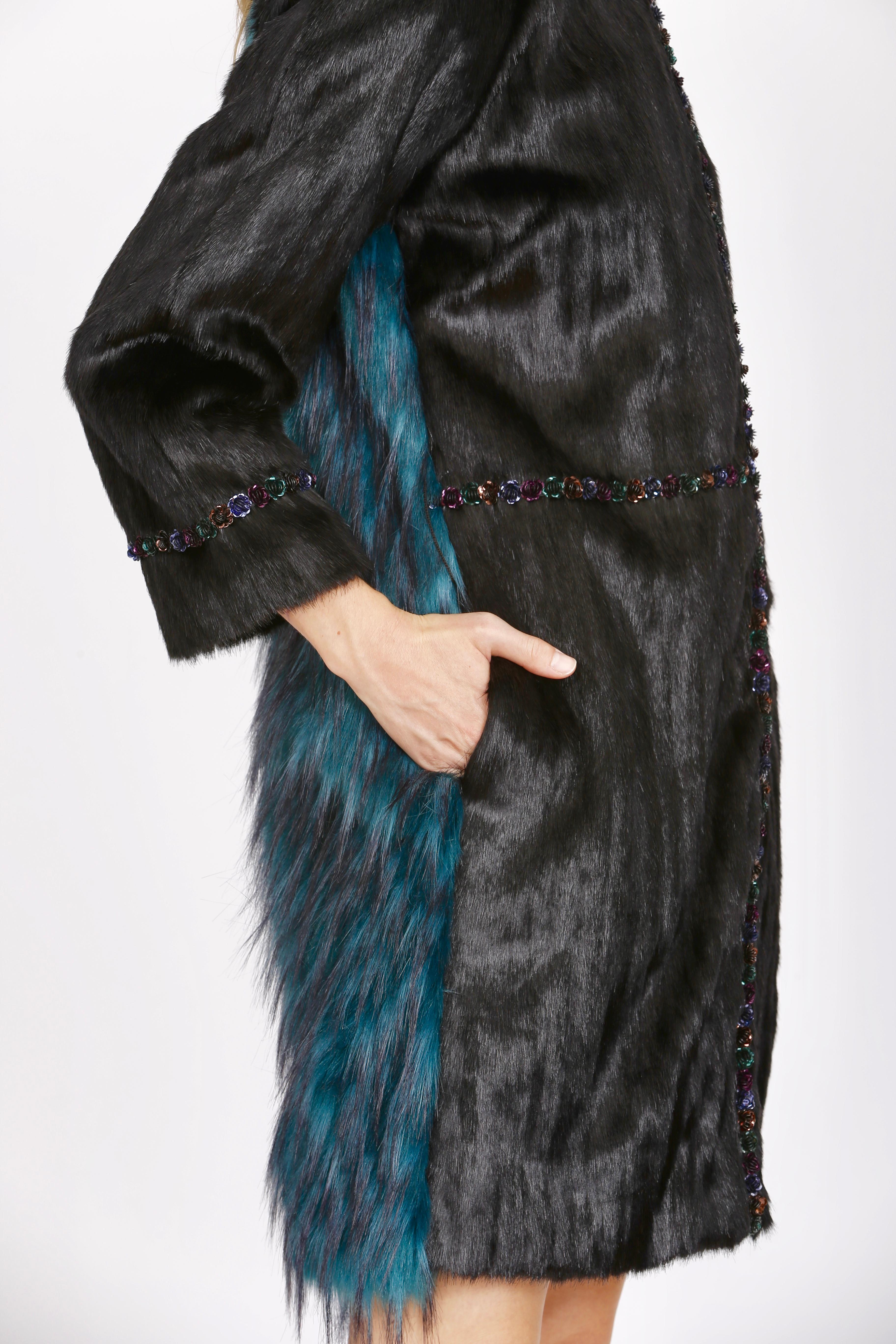 The Jade Pelush black and emerald green faux fur coat is a one of a kind exclusive piece. Featuring the best man made pelage, this stylish bi-color winter coat is a beautiful replica of the mink and fox fur. The two different textures are in perfect