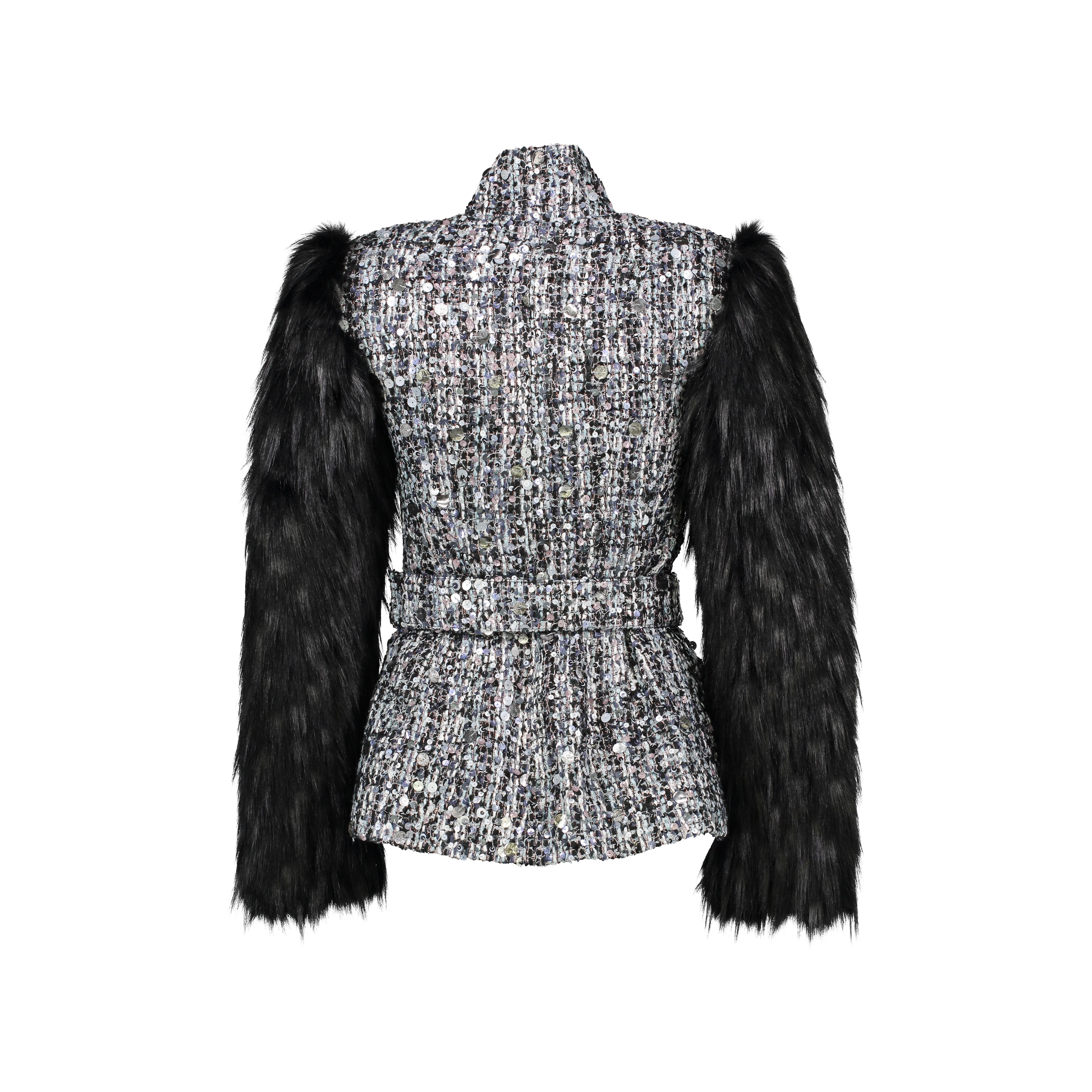 The Bridget Pelush black tweed jacket with sequins and faux fur fox sleeves is a one of a kind exclusive piece. The sophisticated Couture metallic tweed fabric features an intricate combination of sparkling iridescent sequins in black, silver,