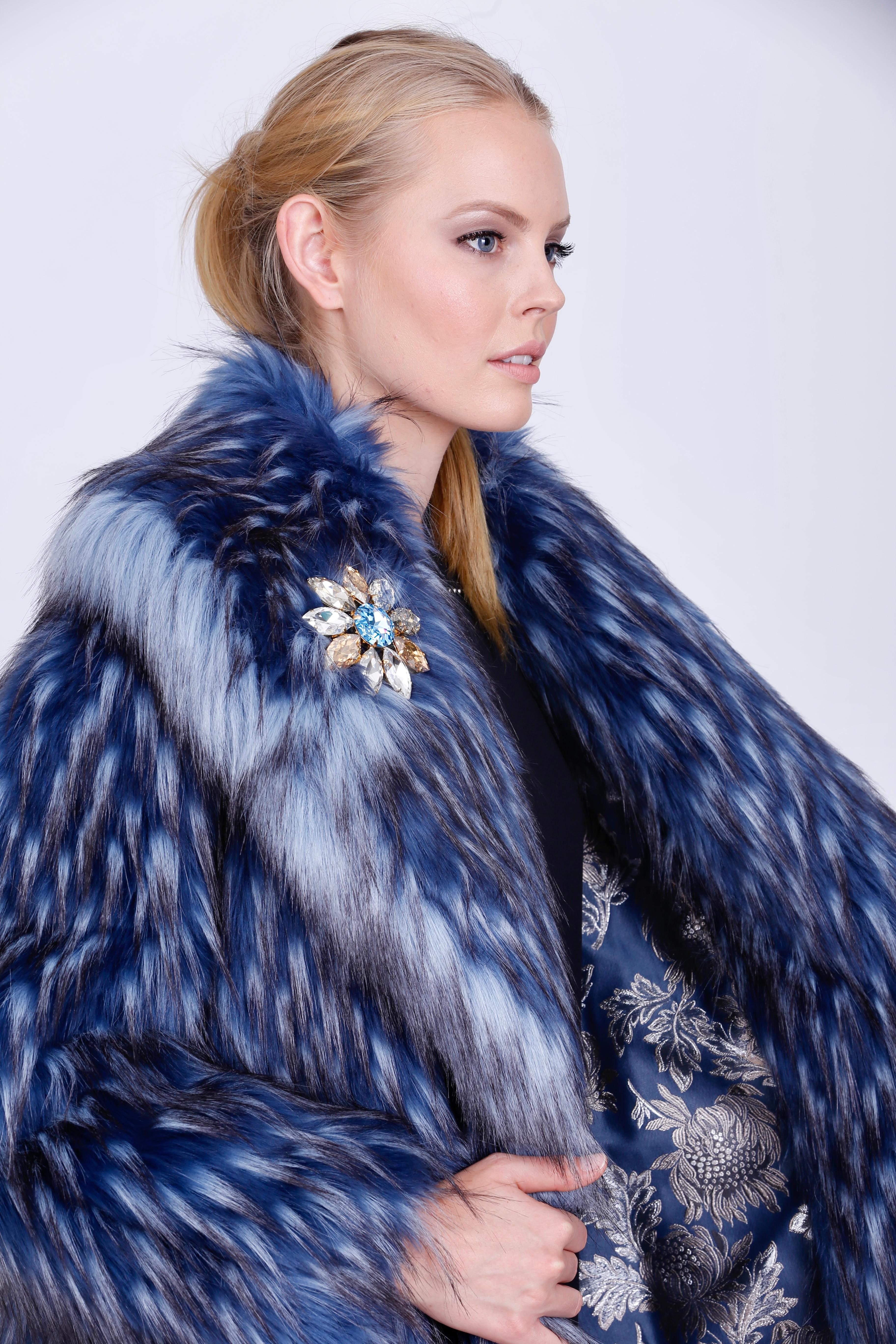 The Pelush Anna blue fox faux fur coat with revere' collar is a one of a kind exclusive piece. Featuring the highest man made pelage in the world, this striking coat is an outstanding replica of the fox fur. Extremely warm and ideal for the coldest