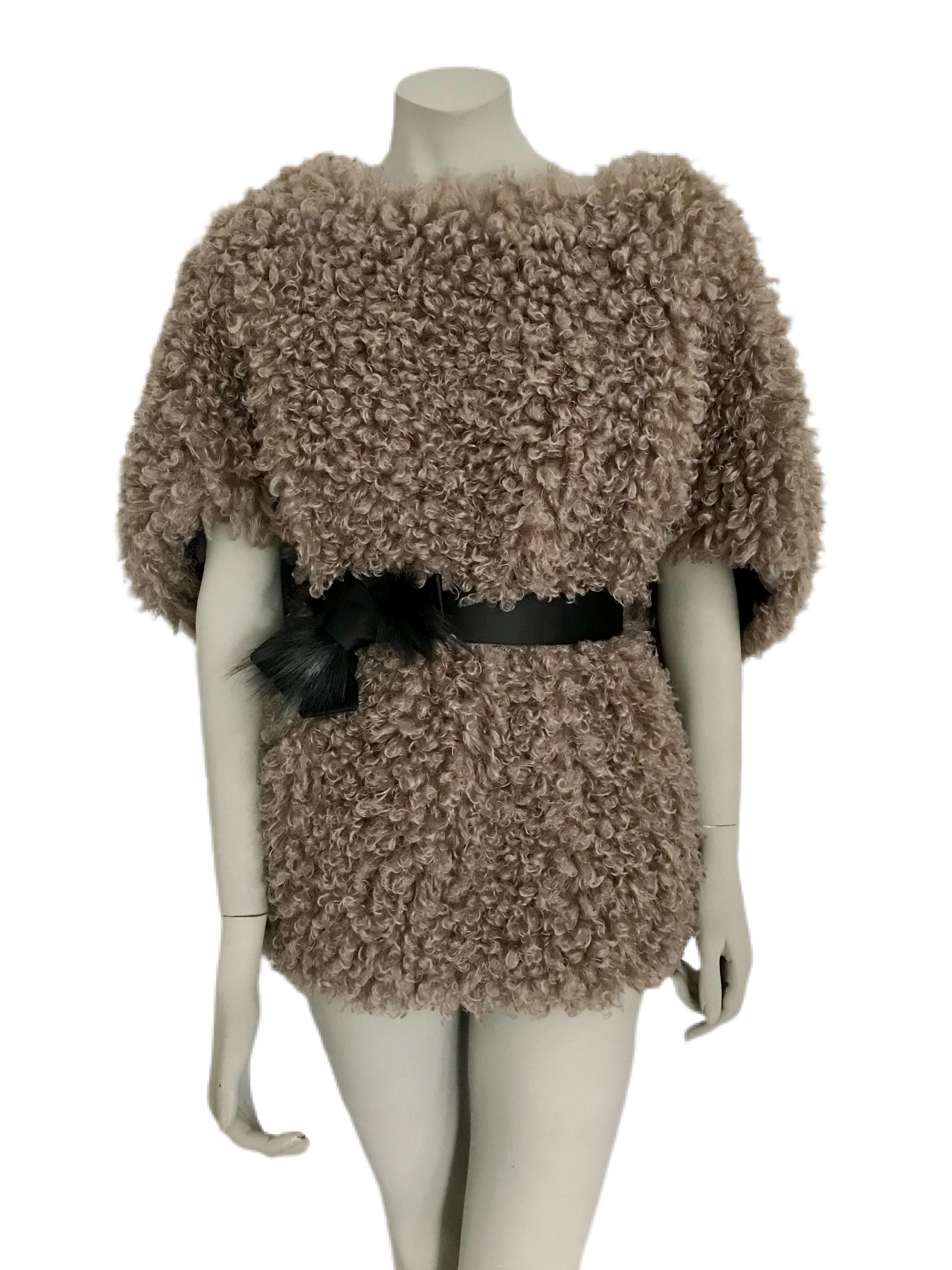 The Pelush faux fur reversible top is a one of a kind exclusive piece. Featuring a striking silk charmeuse fabric in a bold floral print on one side, and a soft curly boucle' faux fur in a soft mushroom color on the opposite side. Extremely