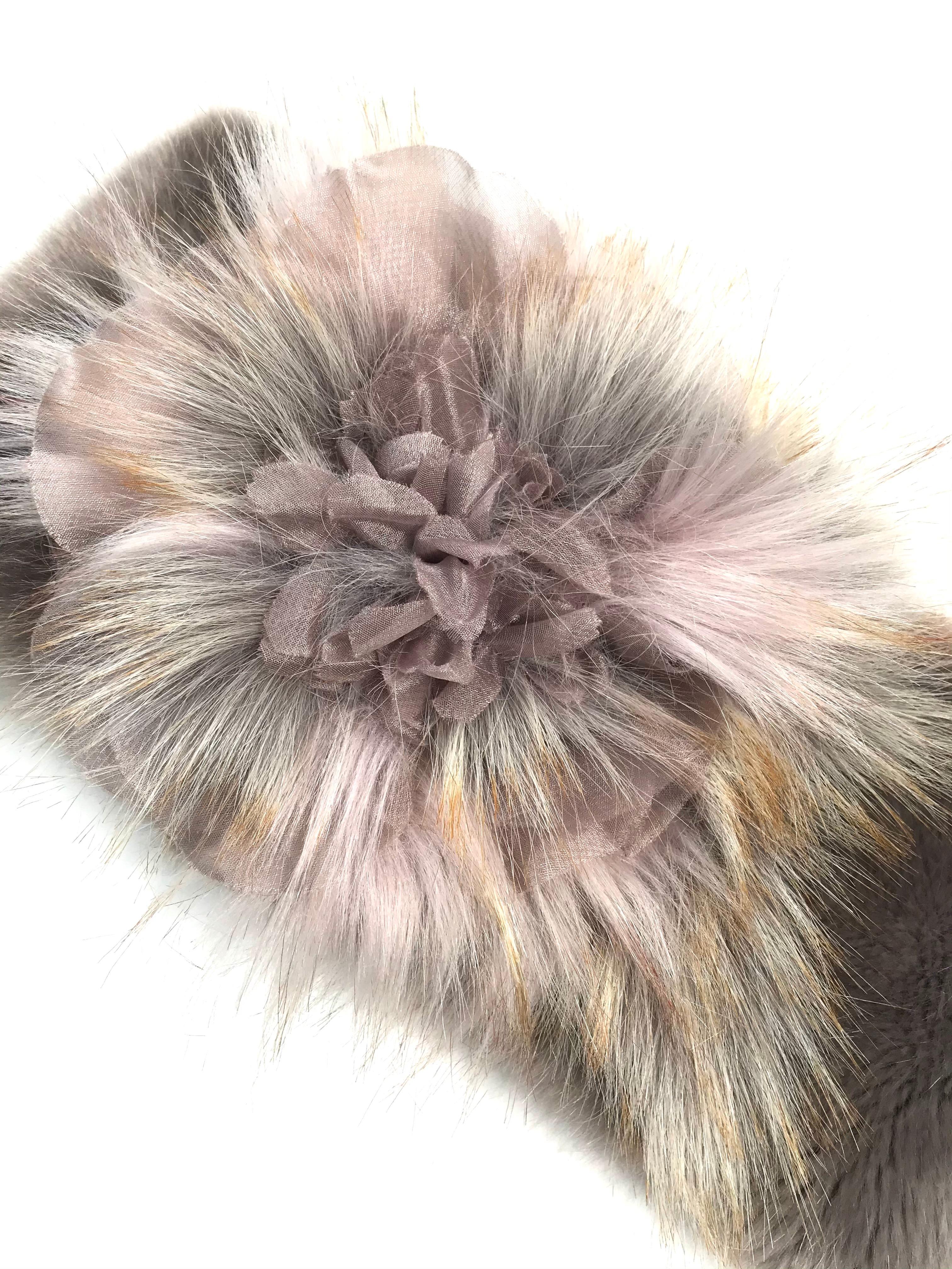 The Pelush faux fur neck warmer/hat is a one of a kind exclusive piece. Featuring the highest quality man made pelage, this elegant and unique scarf in mauve and pink tones is a stunning replica of the mink and fox fur. Wear it around your neck or