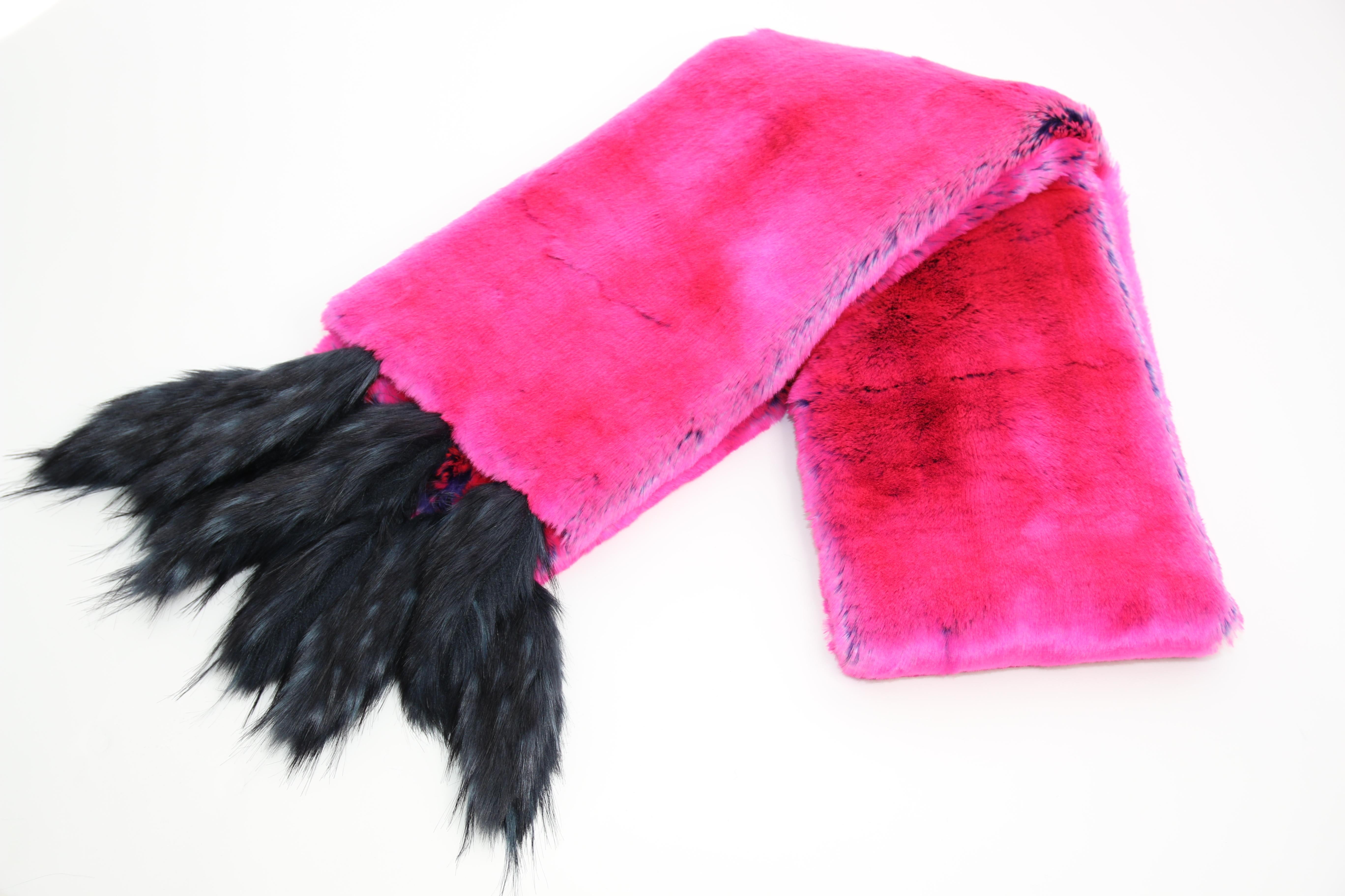 The Rosa Pelush fuchsia faux fur chinchilla stole/shawl with blue faux fox fringes is a one of a kind exclusive piece. Featuring the highest quality man made pelage, this eye-catching stole is an extraordinary replica of the chinchilla and fox fur.