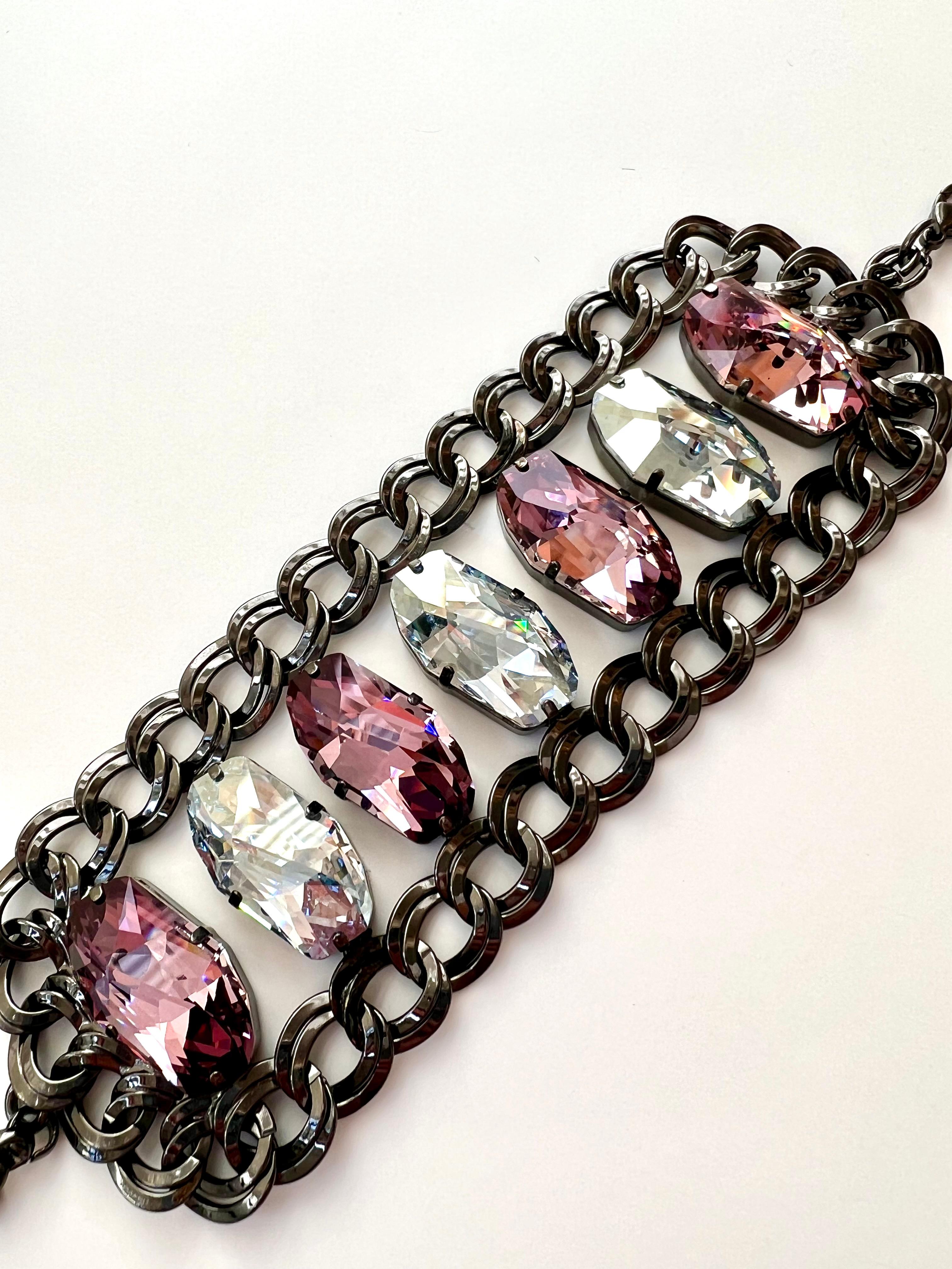 Beautiful Pink and clear Swarowsky statement bracelet, showcasing a mix of modern cut large crystals that emanates dazzling light with each movement. Made in Florence by local master artisans which have a long heritage of metalworking techniques.