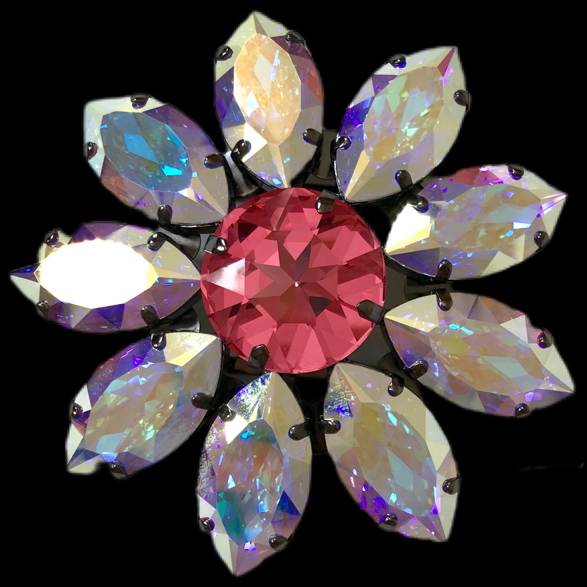 The Pelush pink and opal Swarowsky crystal flower brooch is a one of a kind exclusive piece. Made for Pelush by Florentine artisans in Italy, this striking statement jewelry can be utilized in many different ways. The modern daisy design features a